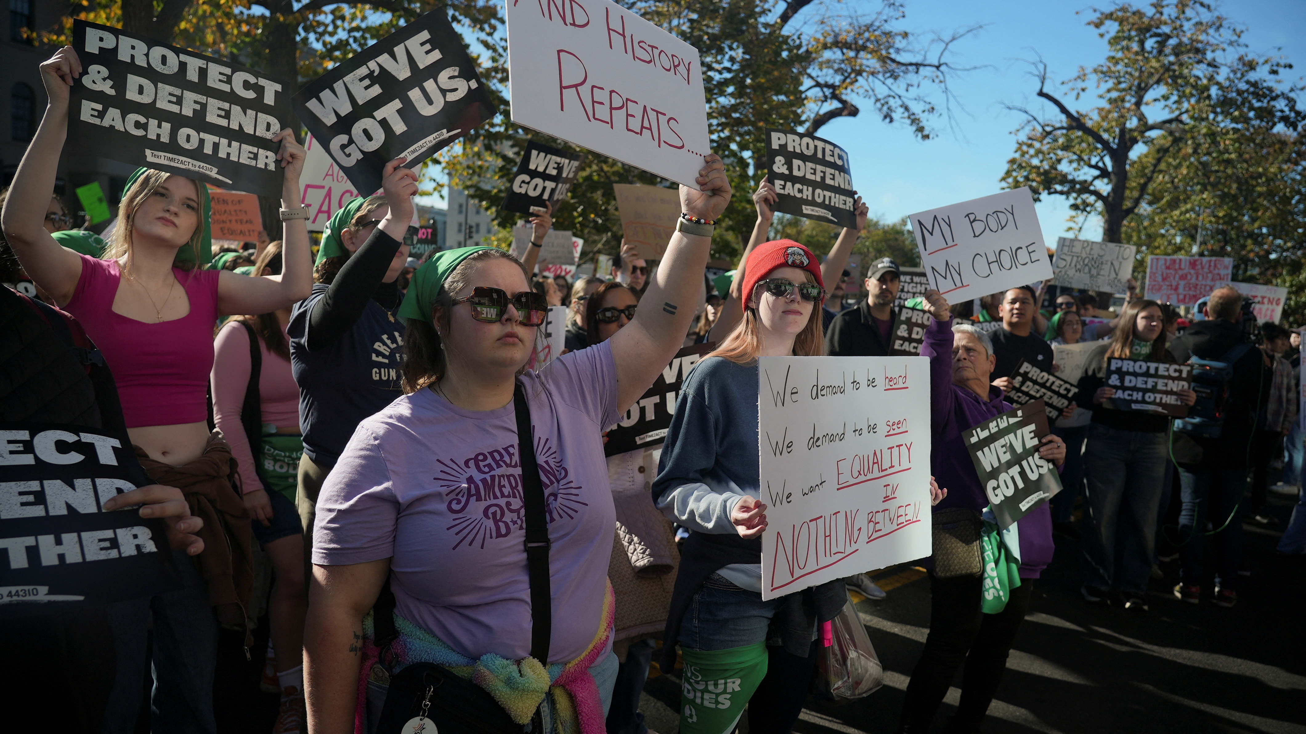 Protesters hold banners during a pro-women’s rights demonstration, days after Donald Trump’s victory in the presidential election, in Washington, DC, US, November 9, 2024