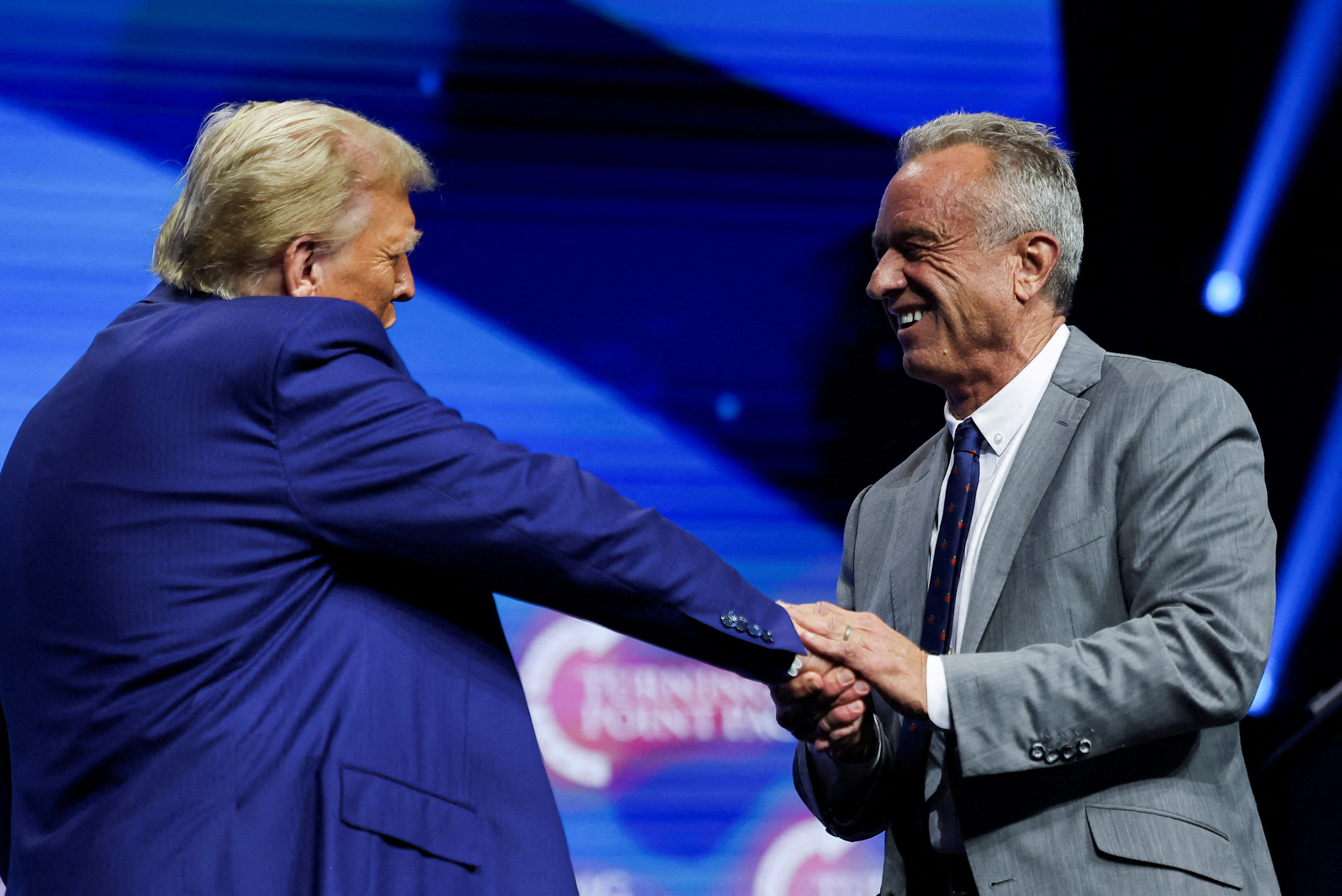 Robert F Kennedy Jr shakes hands with Donald Trump