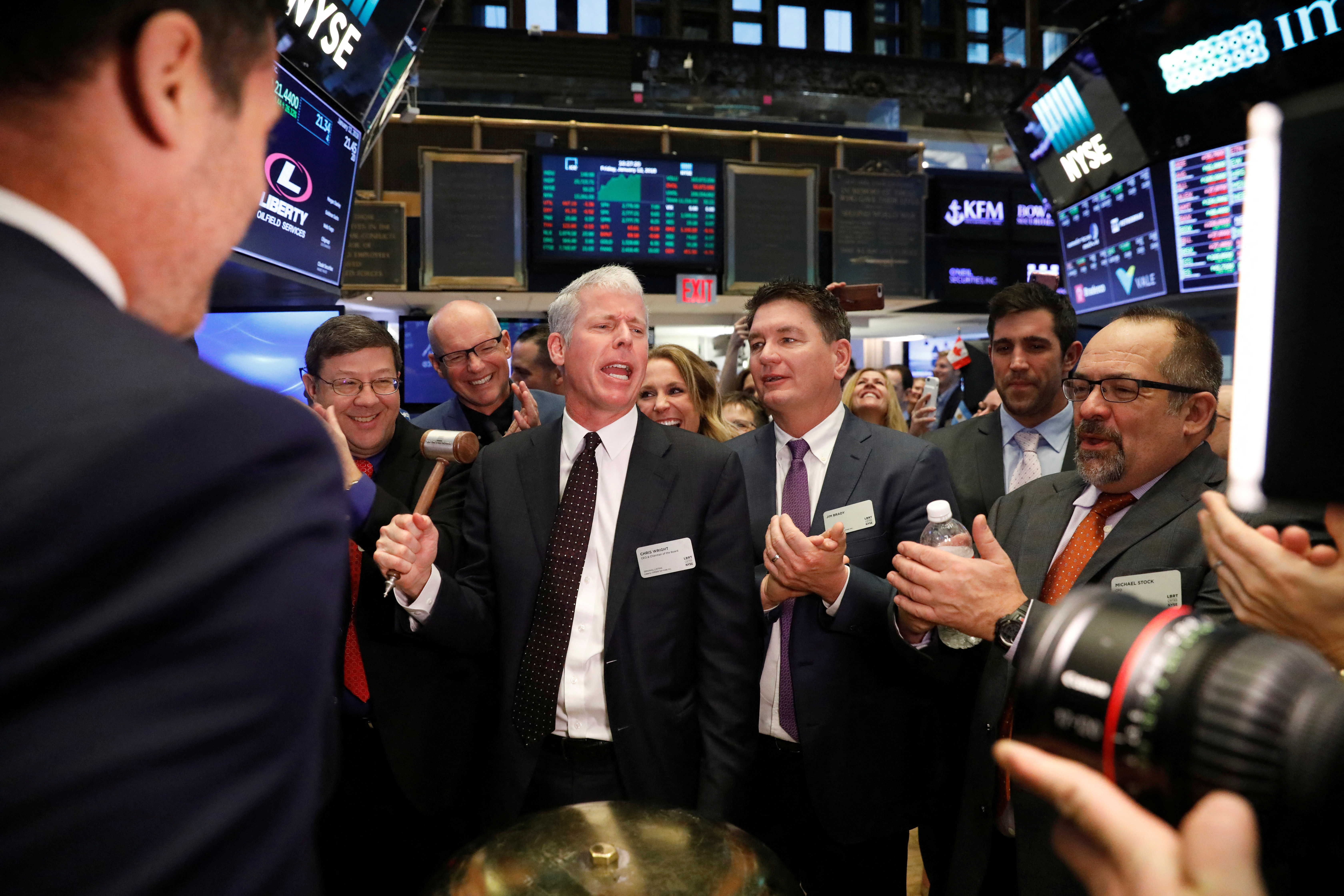 Chris Wright rings the ceremonial bell at the New York Stock Exchange.