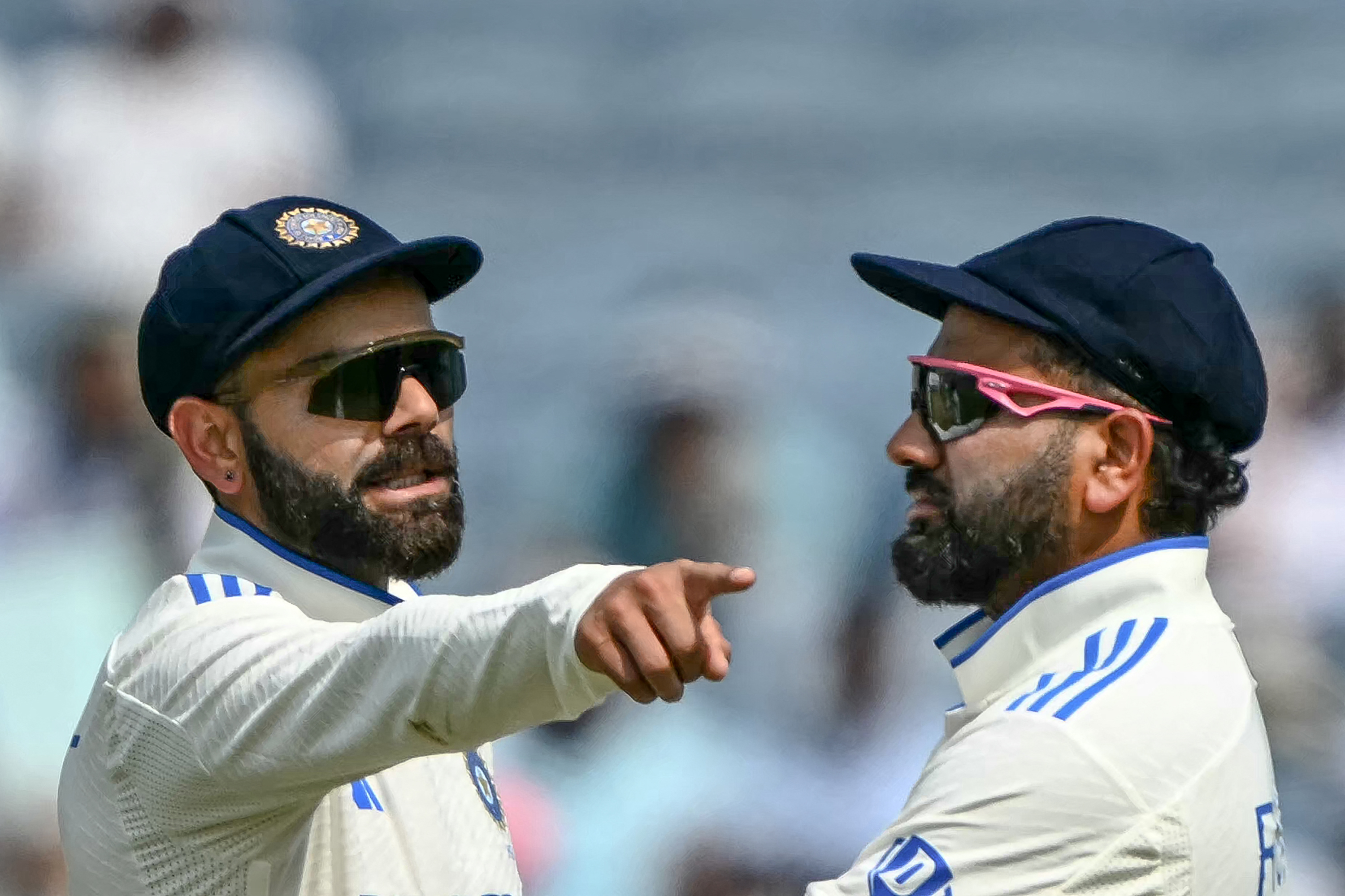 India's Virat Kohli talks with his captain Rohit Sharma