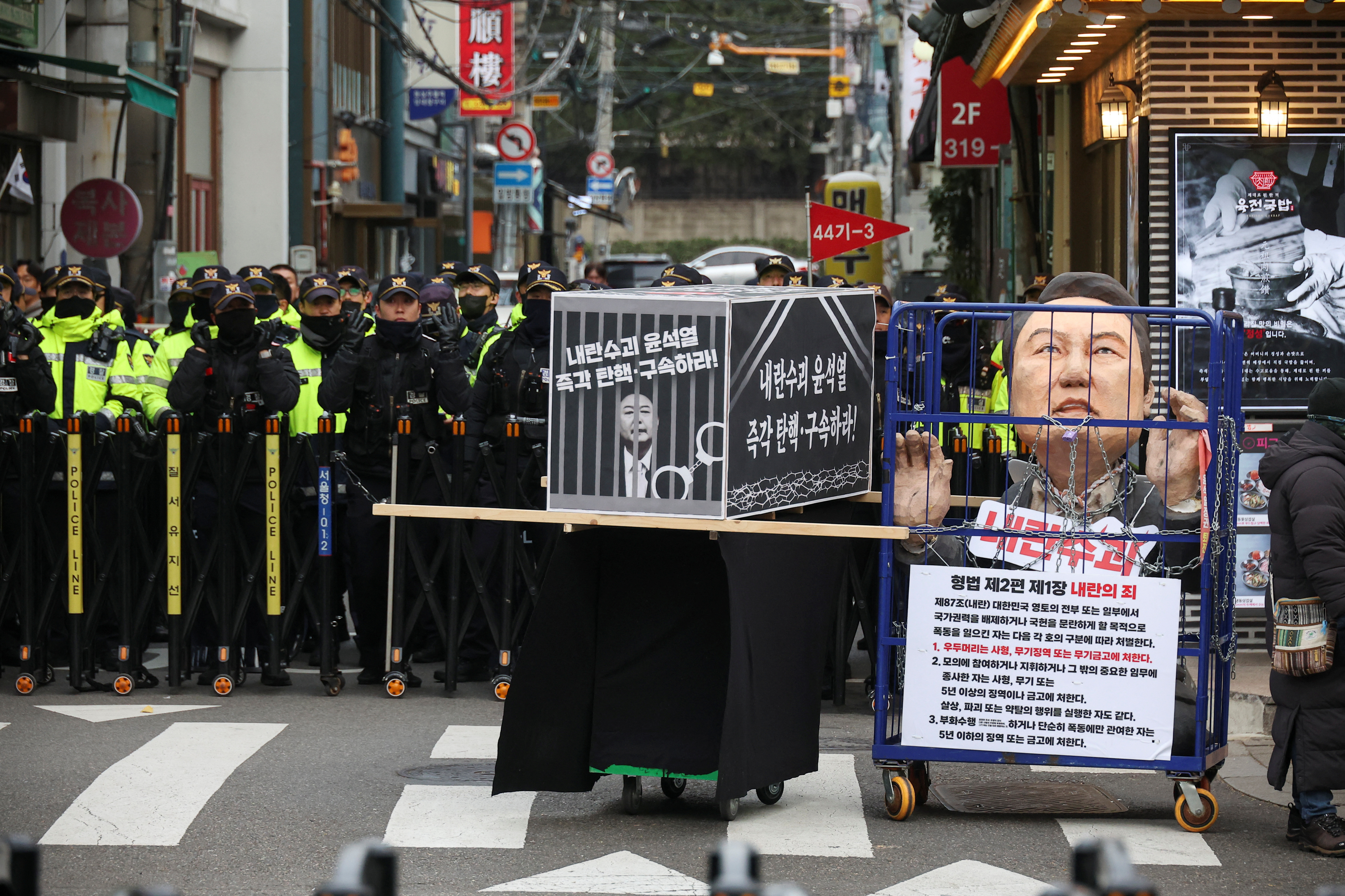 Police block the road to stop protestors marching during a rally calling for the impeachment of South Korean President Yoon Suk Yeol