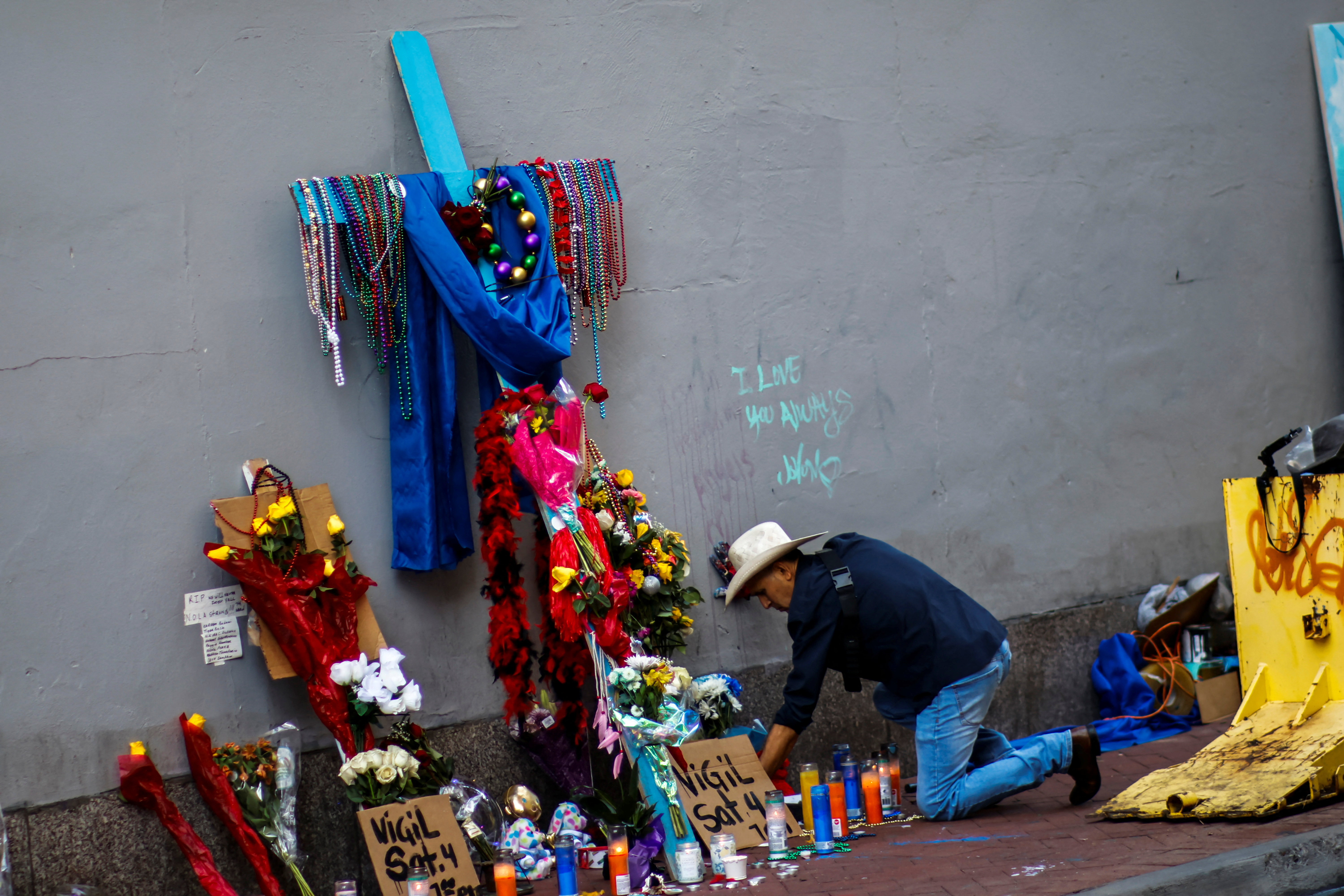 A man organizes candles in a makeshift memorial for the victims at Bourbon's street two days after a U.S. Army veteran drove his truck into the crowded French Quarter on New Year's Day in New Orleans, Louisiana, U.S. January 3