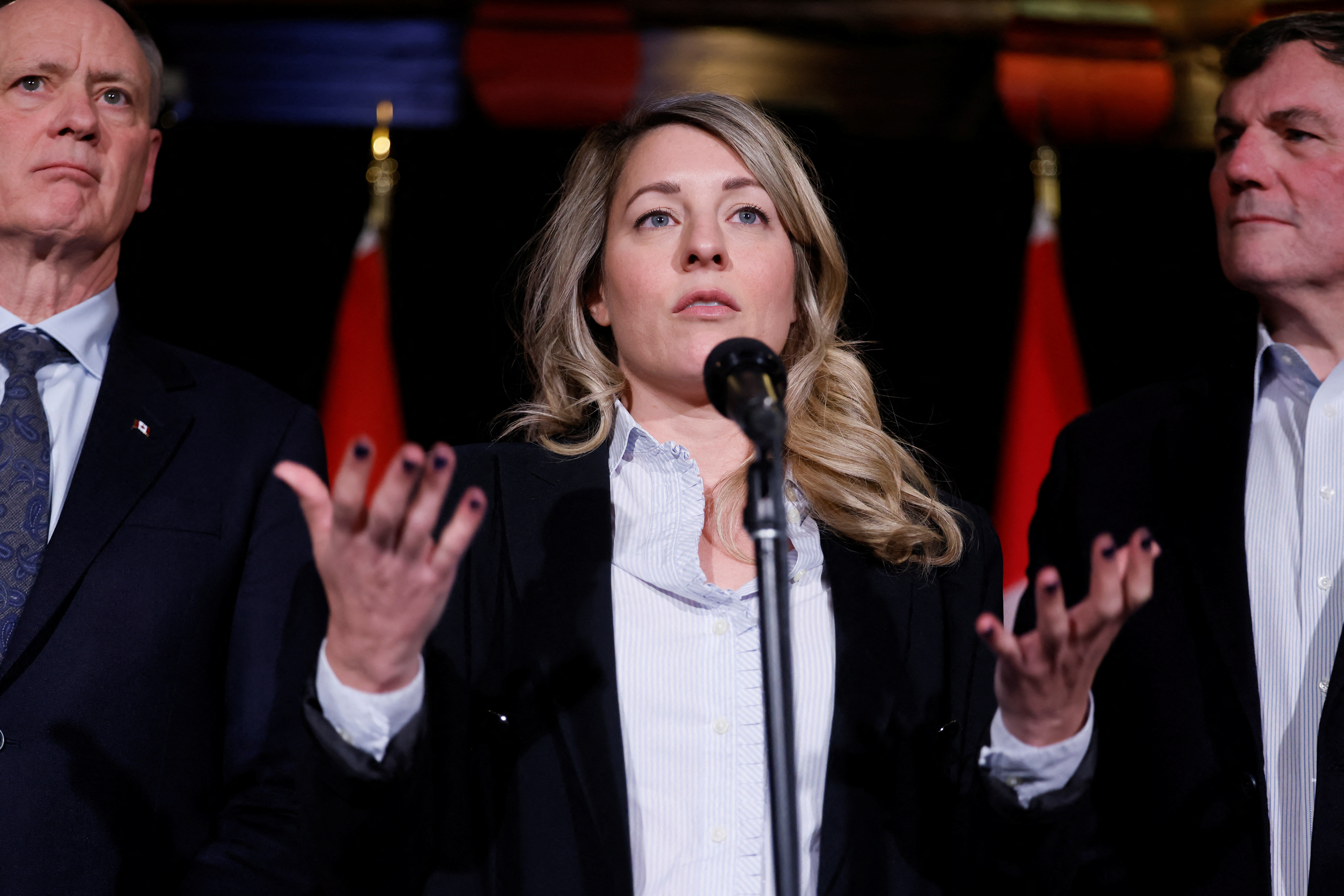 Canadian Foreign Minister Melanie Joly speaks at a microphone