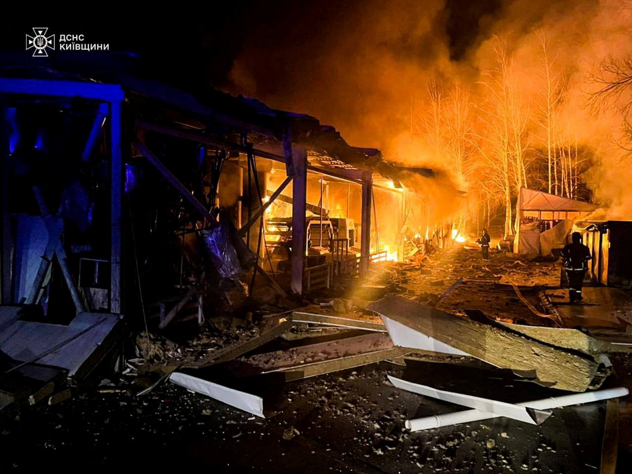Firefighters work at a site of a Russian drone strike