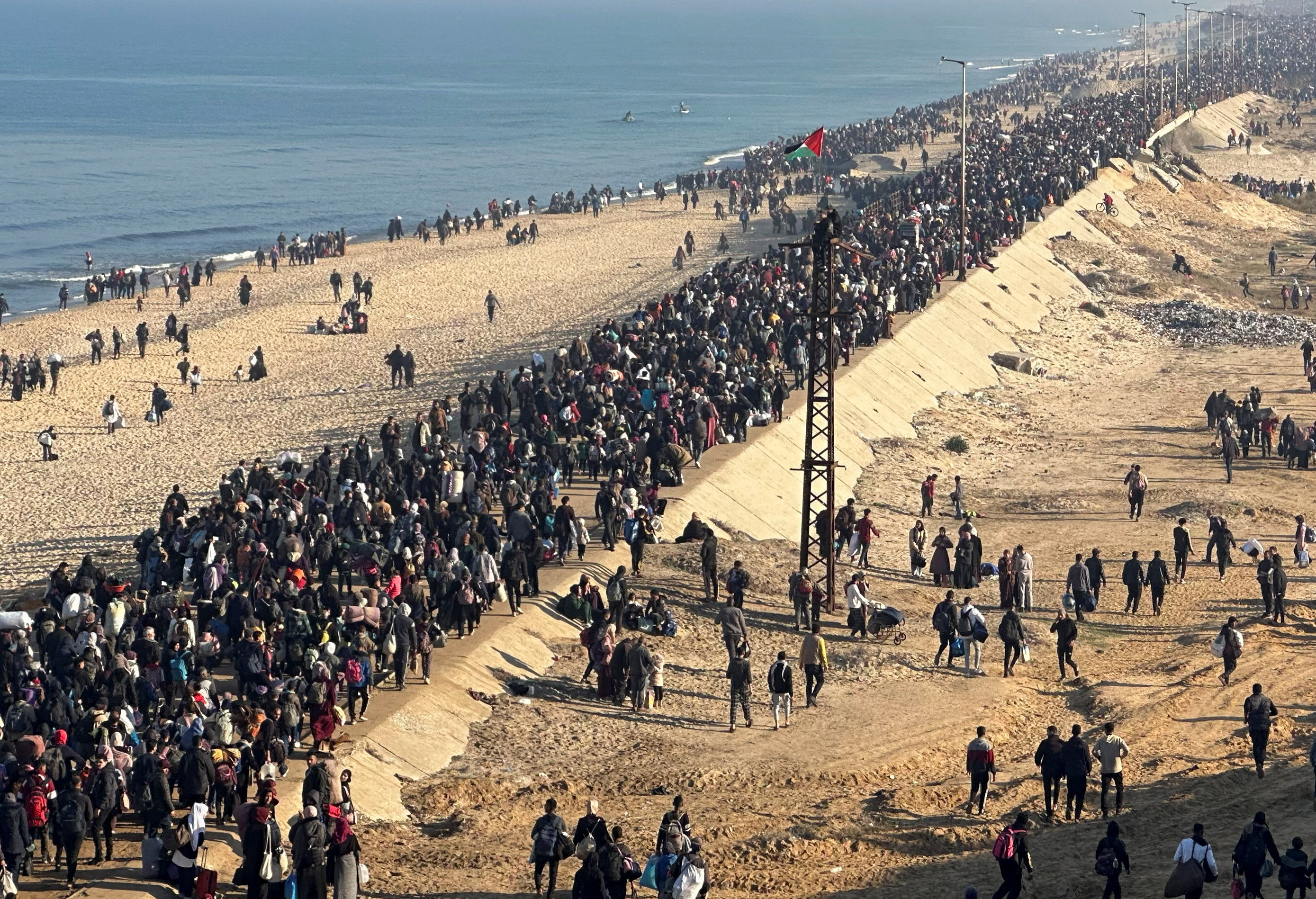 Palestinians walk back to their homes in northern Gaza.
