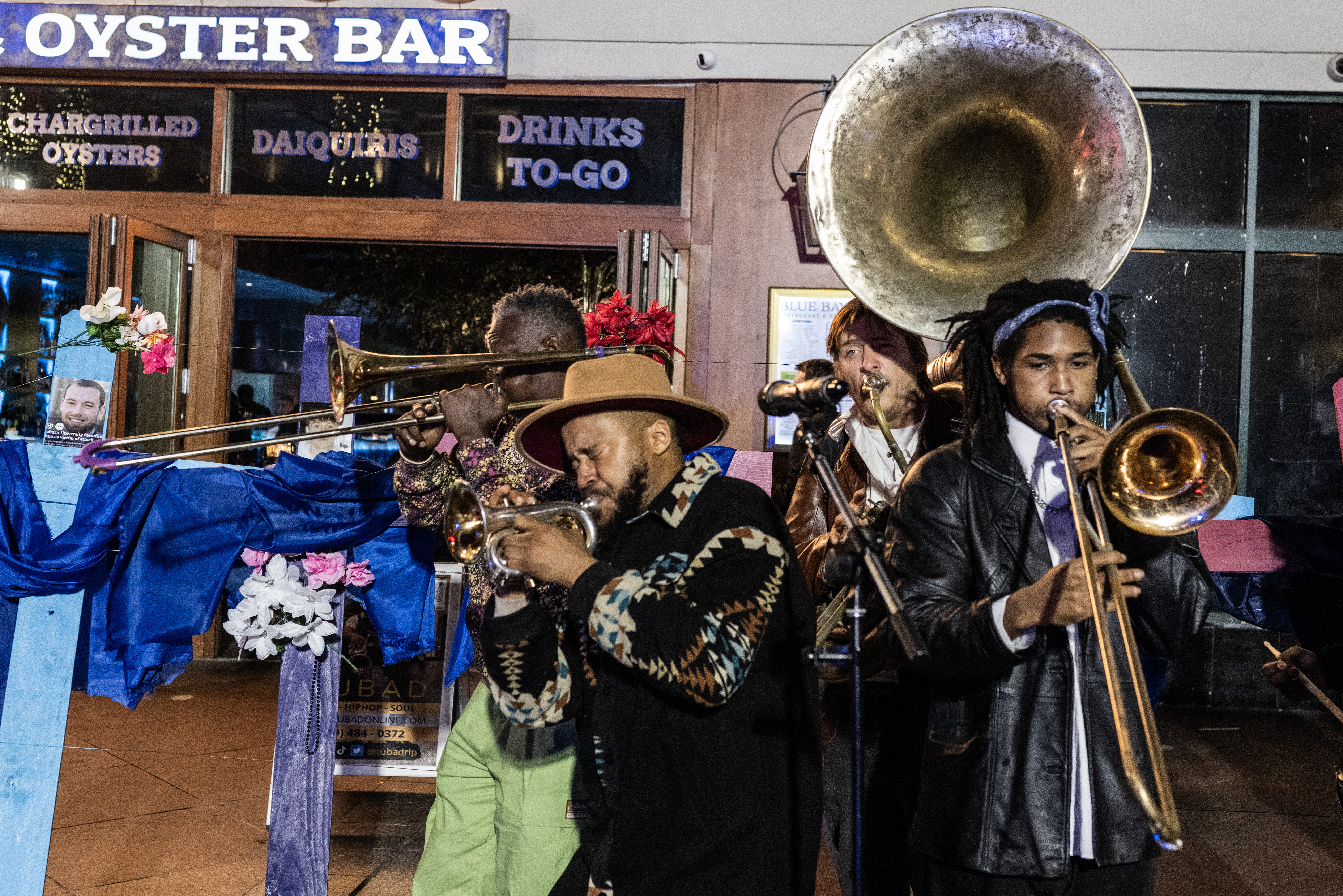 A band plays next to crosses with pictures of victims at a memorial on Bourbon Street after it reopened to the public on January 2
