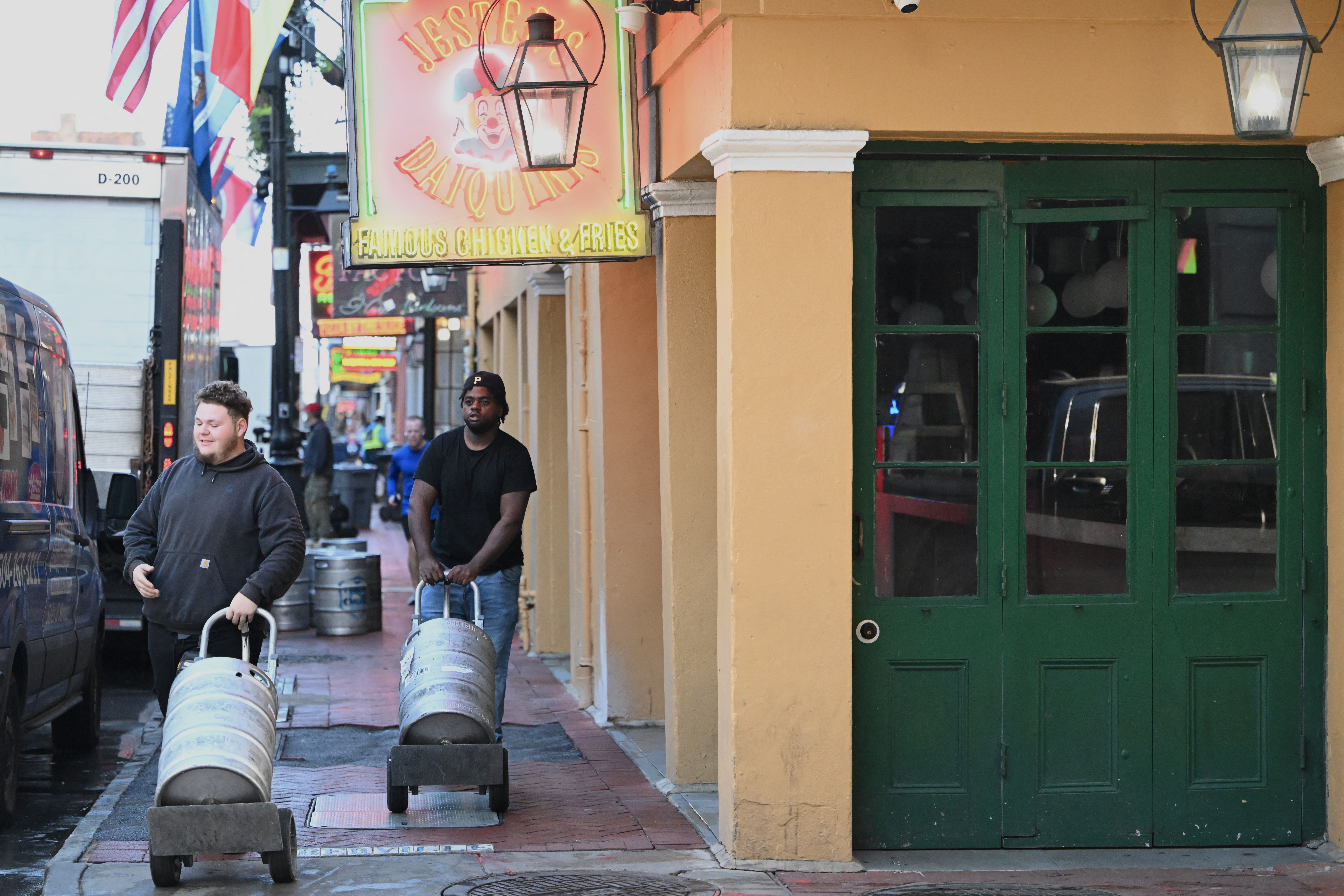 Two men deliver kegs of beer to restock the bars early on Bourbon Street in the French Quarter of New Orleans, Louisiana, on January 3
