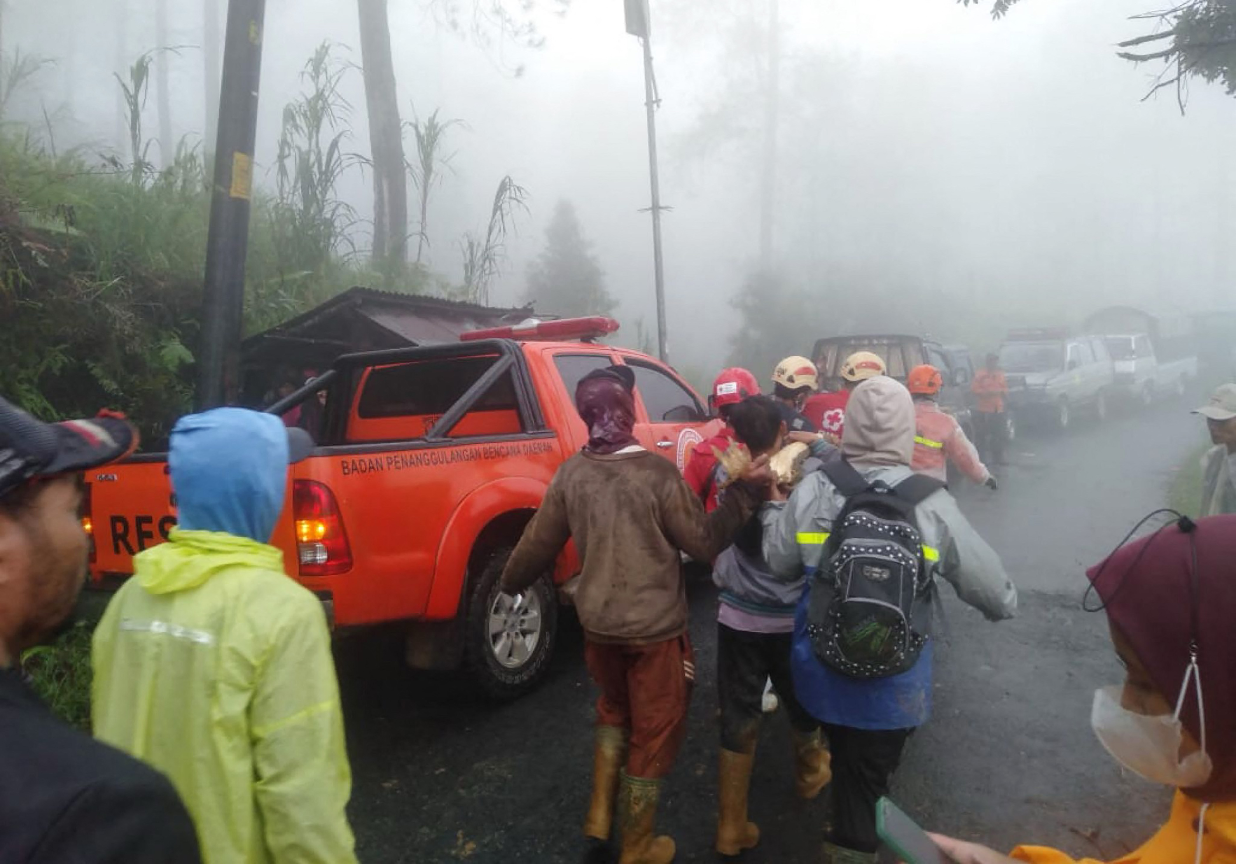 In this handout picture taken and released on January 21, 2025, by the Indonesias Disaster Mitigation Agency shows, rescueers and villagers evacuate victims of a landslide at Kasimpar Village in Pekalongan, Central Java. At least 16 people have been killed and three more are missing after a landslide triggered by heavy rain in Indonesias Central Java province, disaster officials said