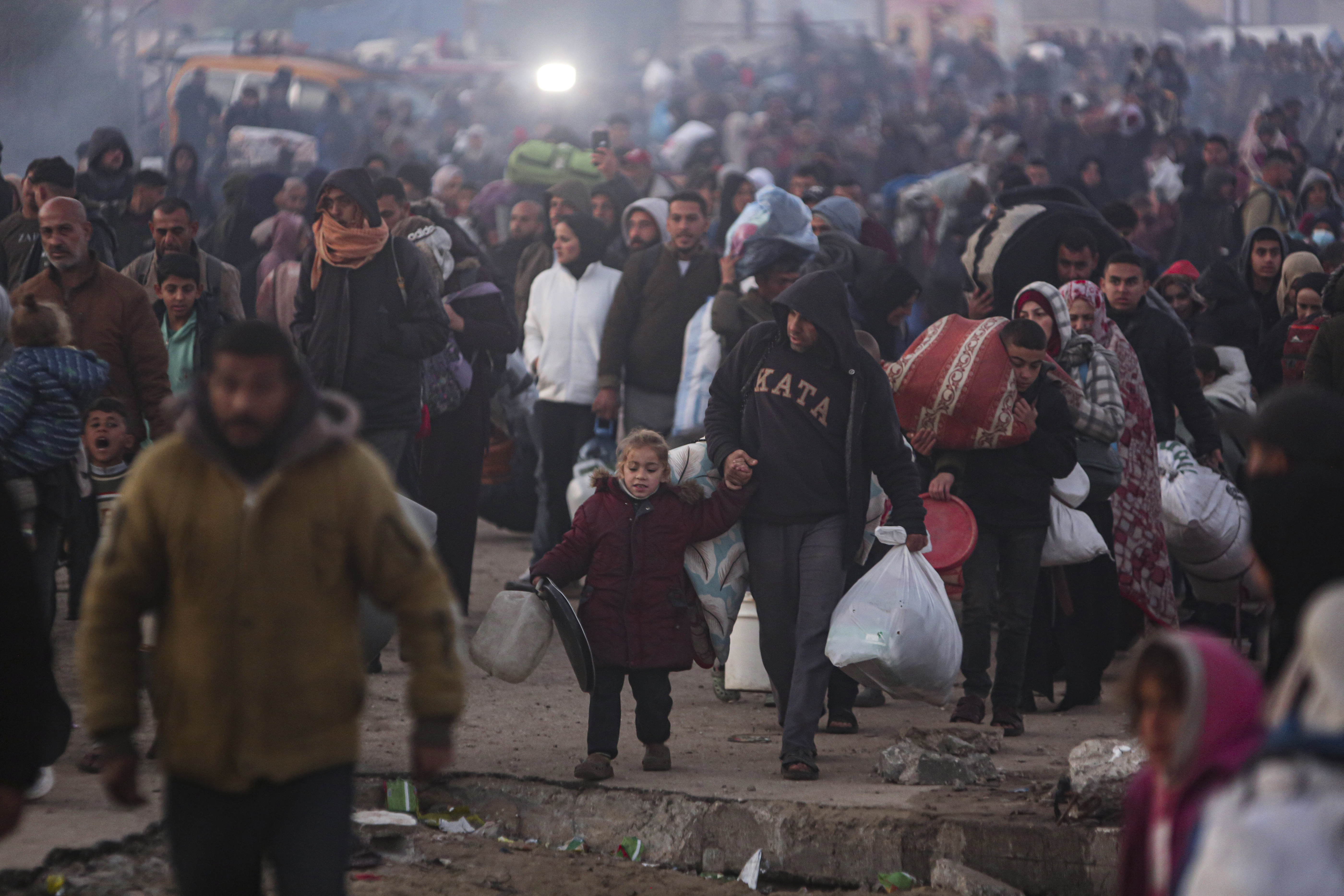 Palestinians walk back to their homes in northern Gaza