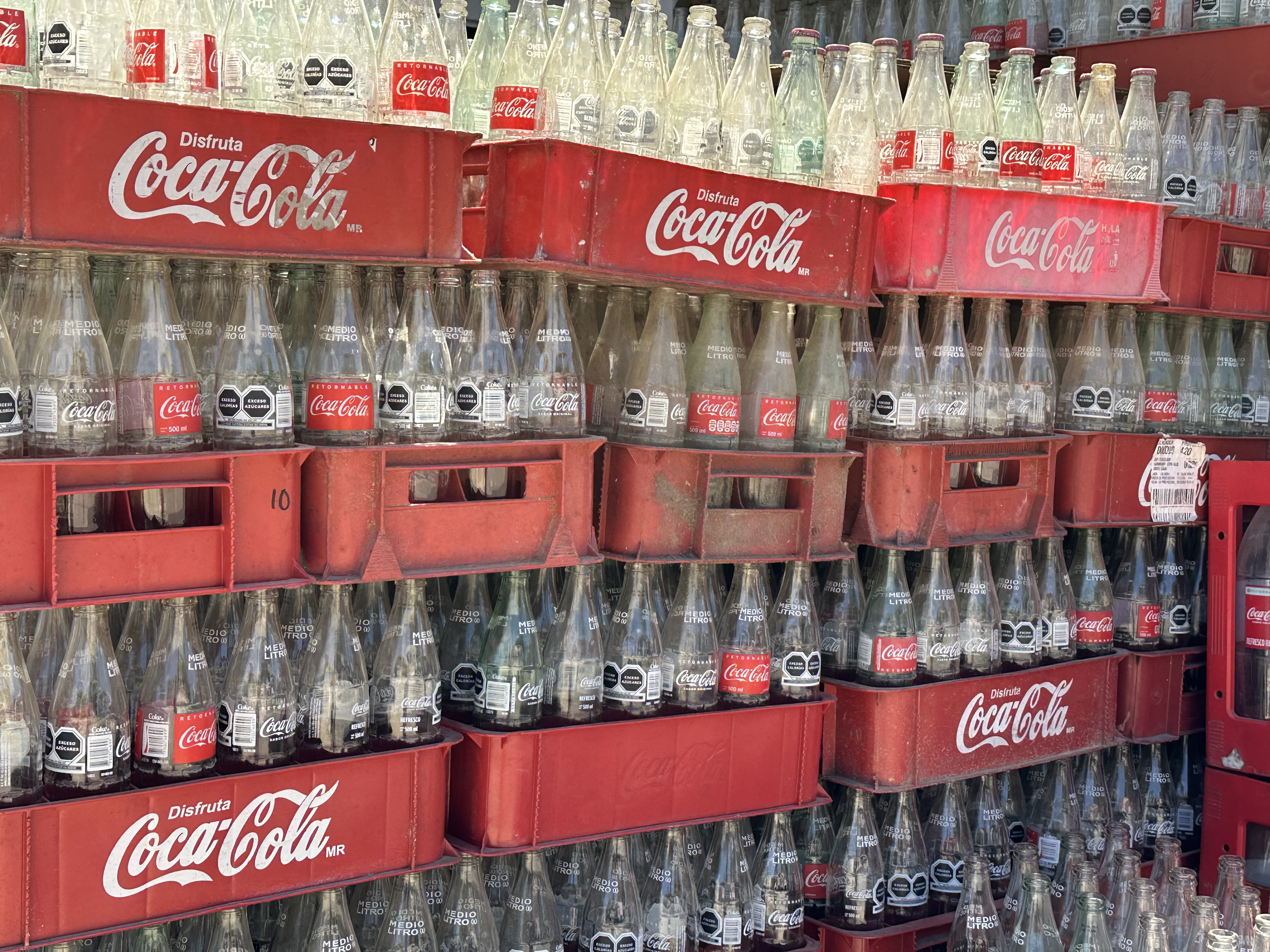 Stacks of empty Coca-Cola bottles in crates