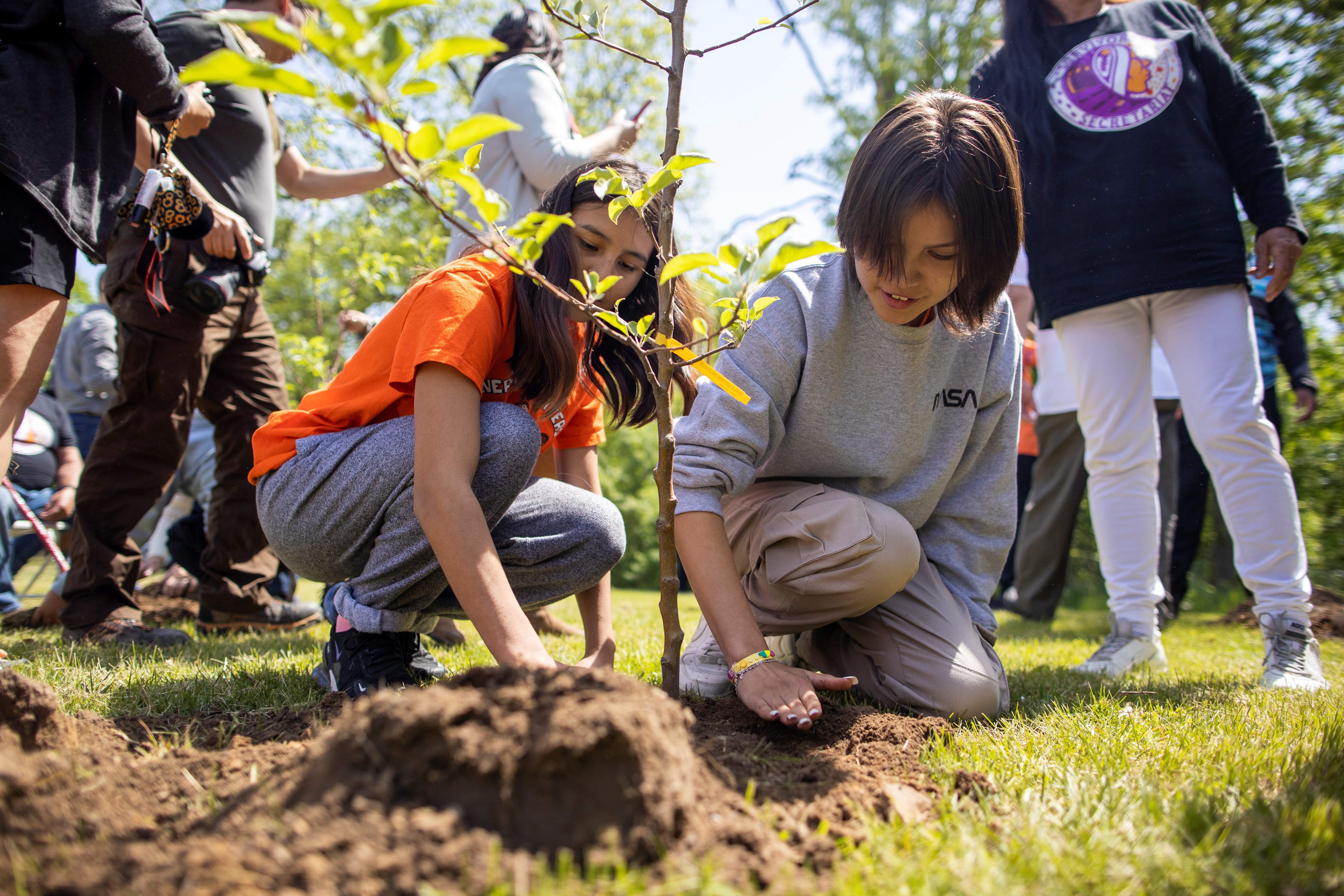 Children plant trees in honour of residential school survivors in Ontario