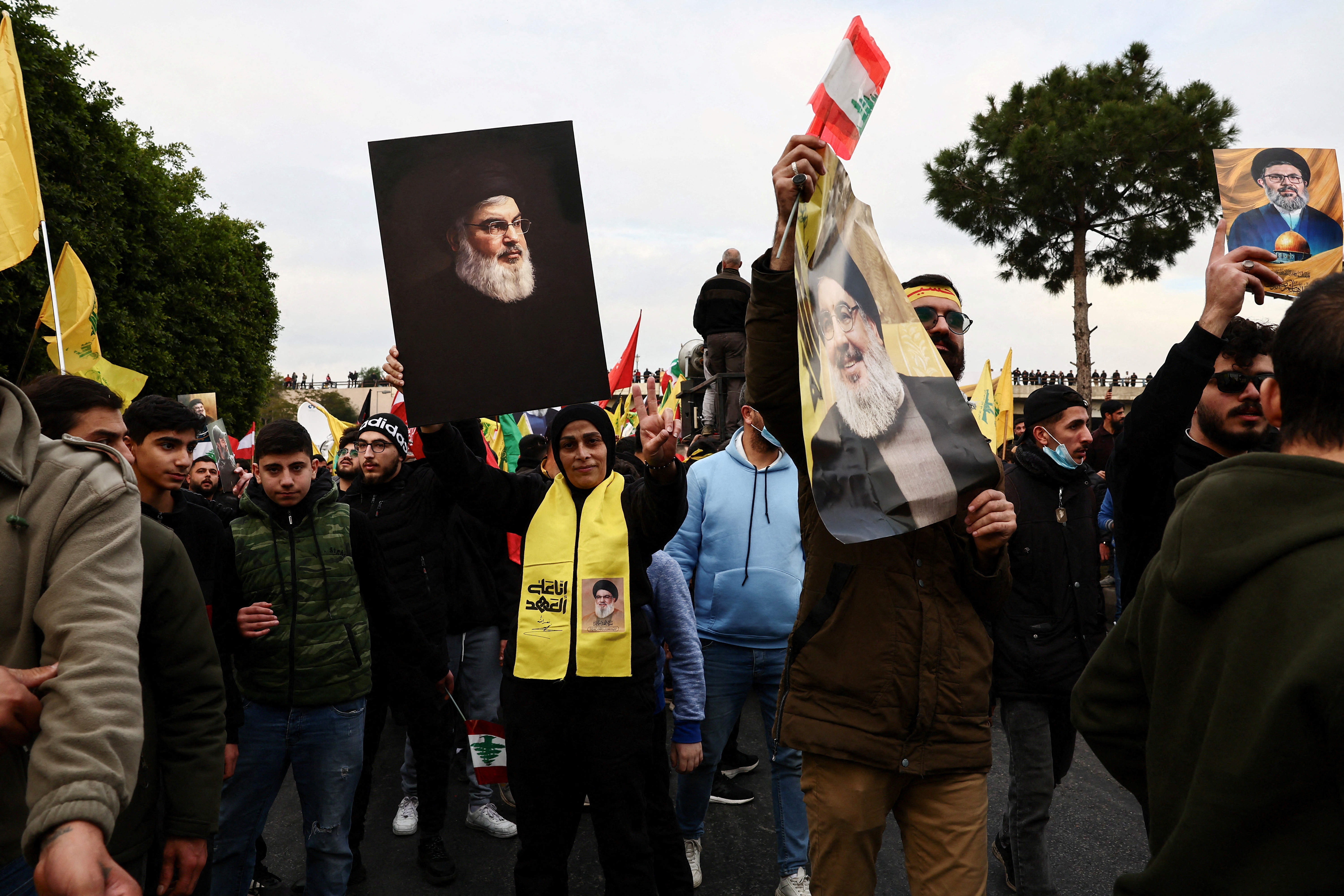 Supporters of Hezbollah carry pictures of late leader Sayyed Hassan Nasrallah at a protest.