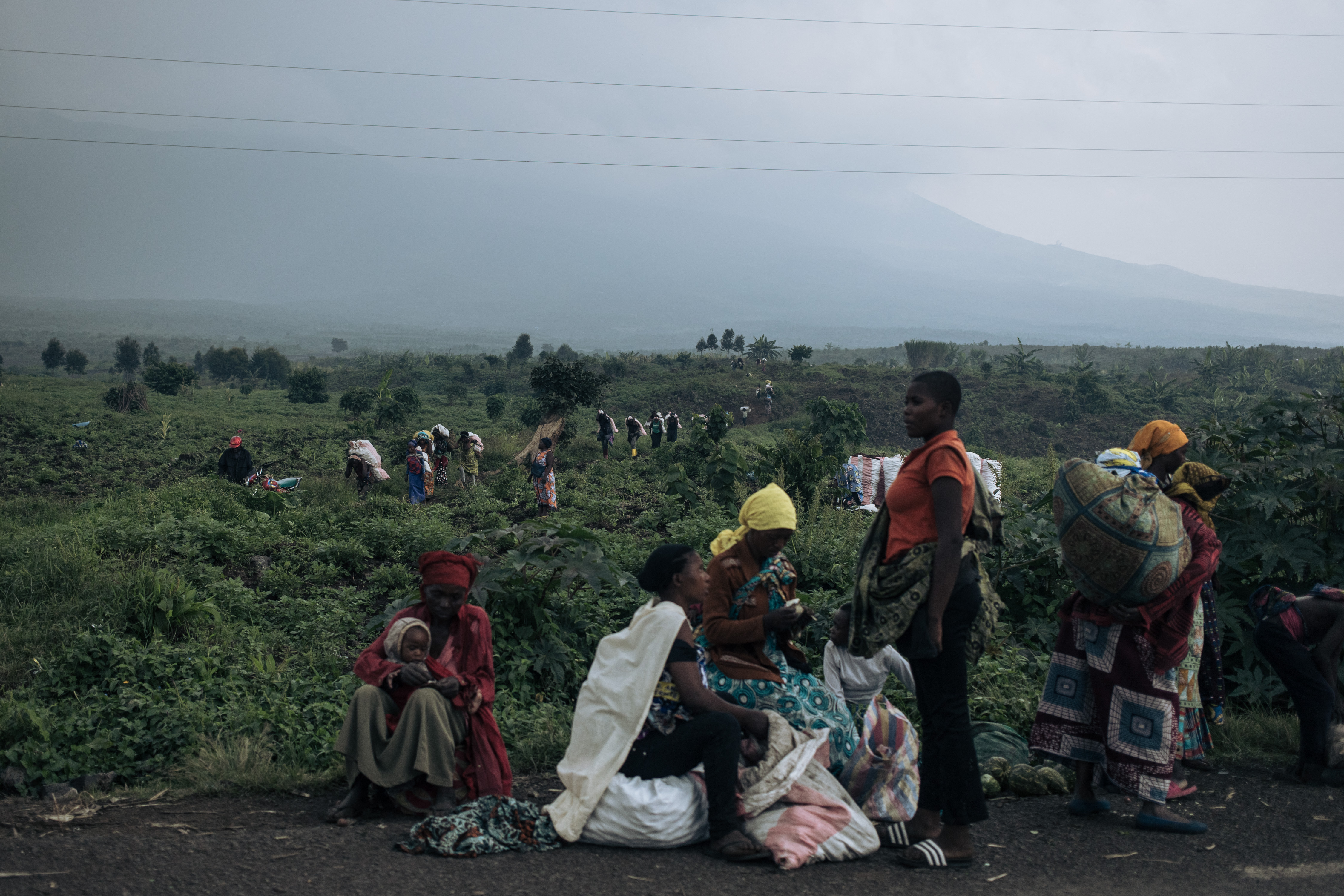 Displaced people gather at a camp near Goma after fleeing fighting in eastern DR Congo, where conflict linked to armed groups has forced millions from their homes