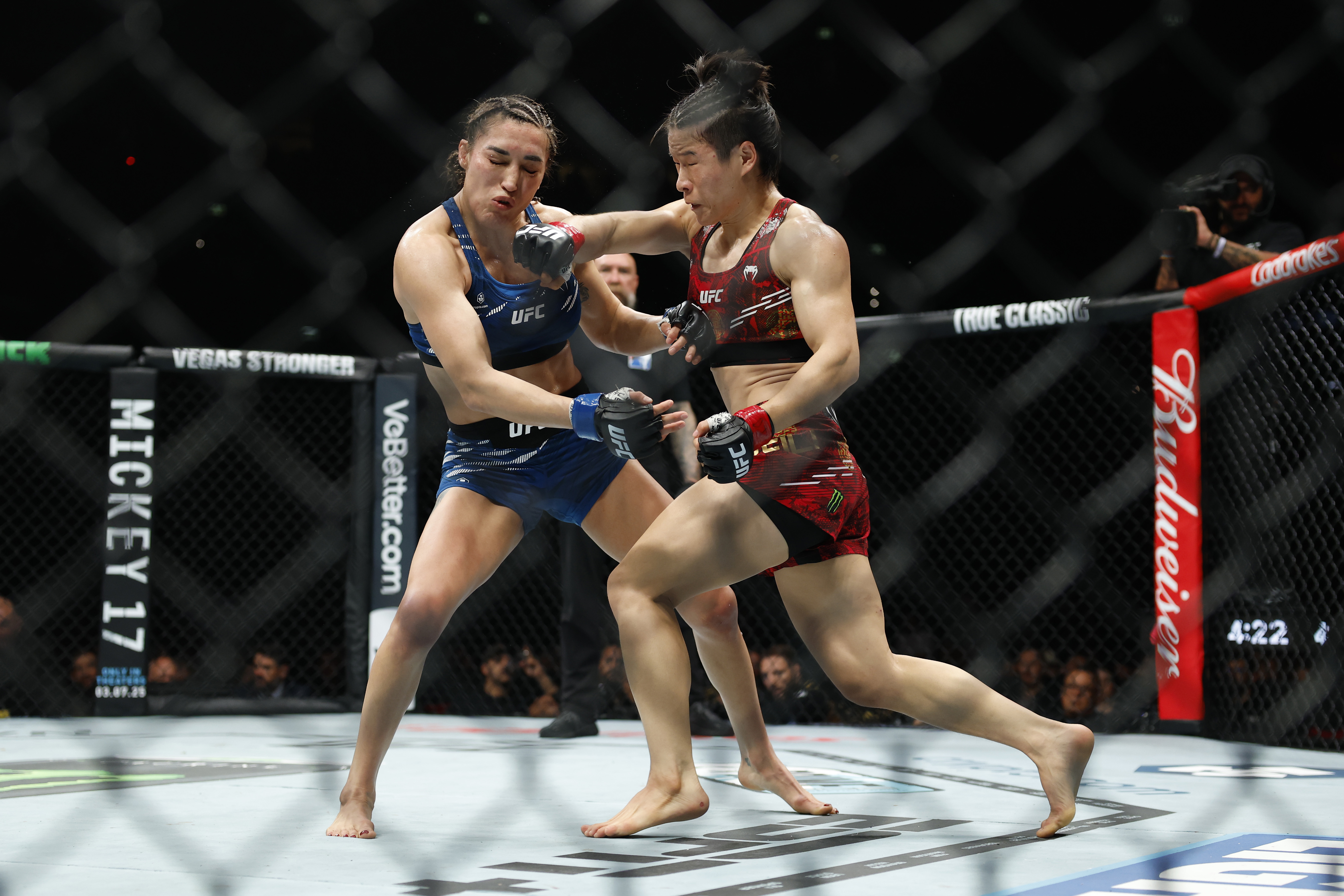 American Tatiana Suarez (L) fights Zhang Weili of China in their strawweight title bout during UFC 312