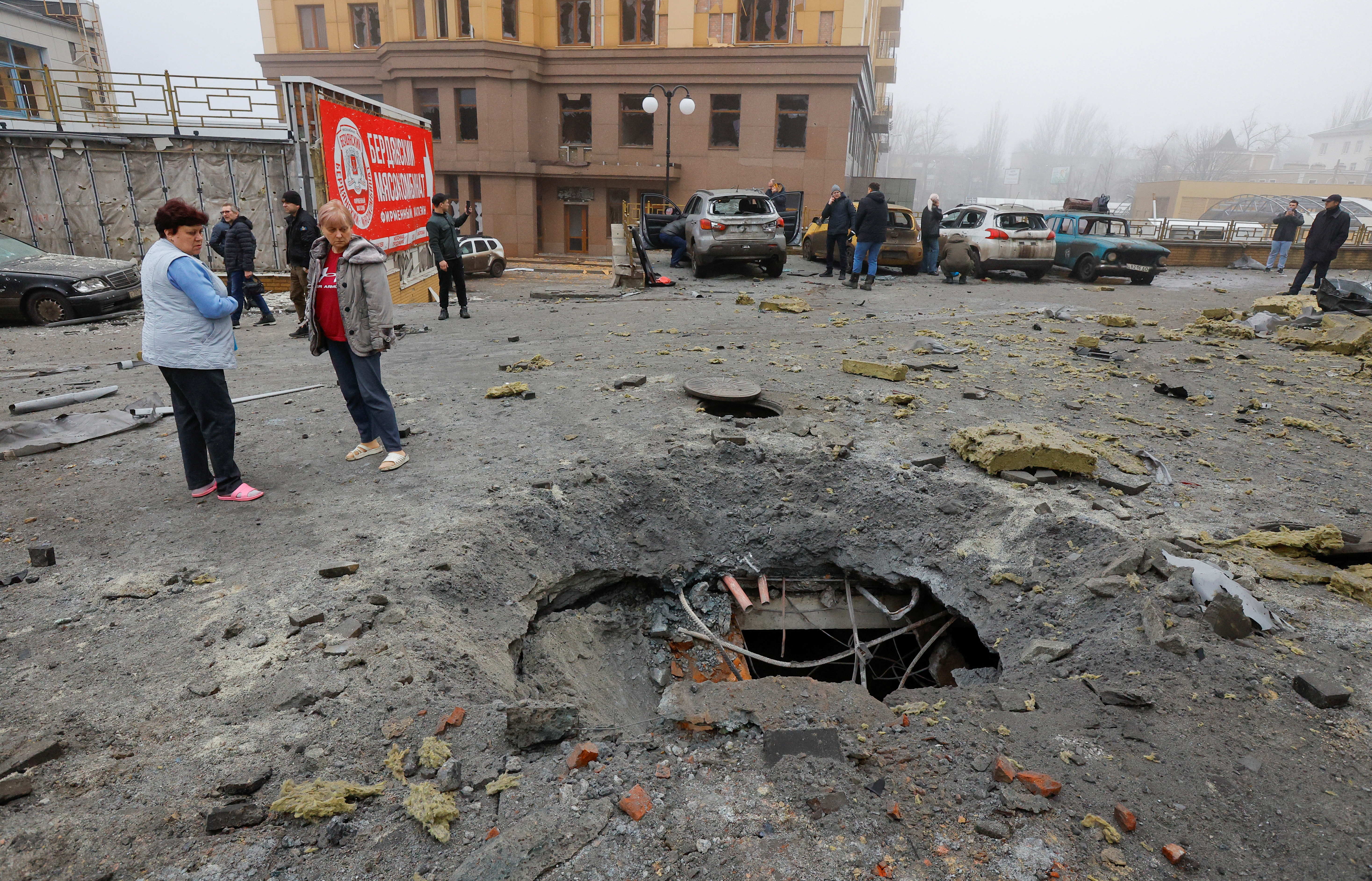 People stand near a damaged store after the shelling, which local Russian-installed authorities called a Ukrainian military strike, in the course of Russia-Ukraine conflict, in Donetsk, Russian-controlled Ukraine, January 10, 2025. REUTERS/Alexander Ermochenko