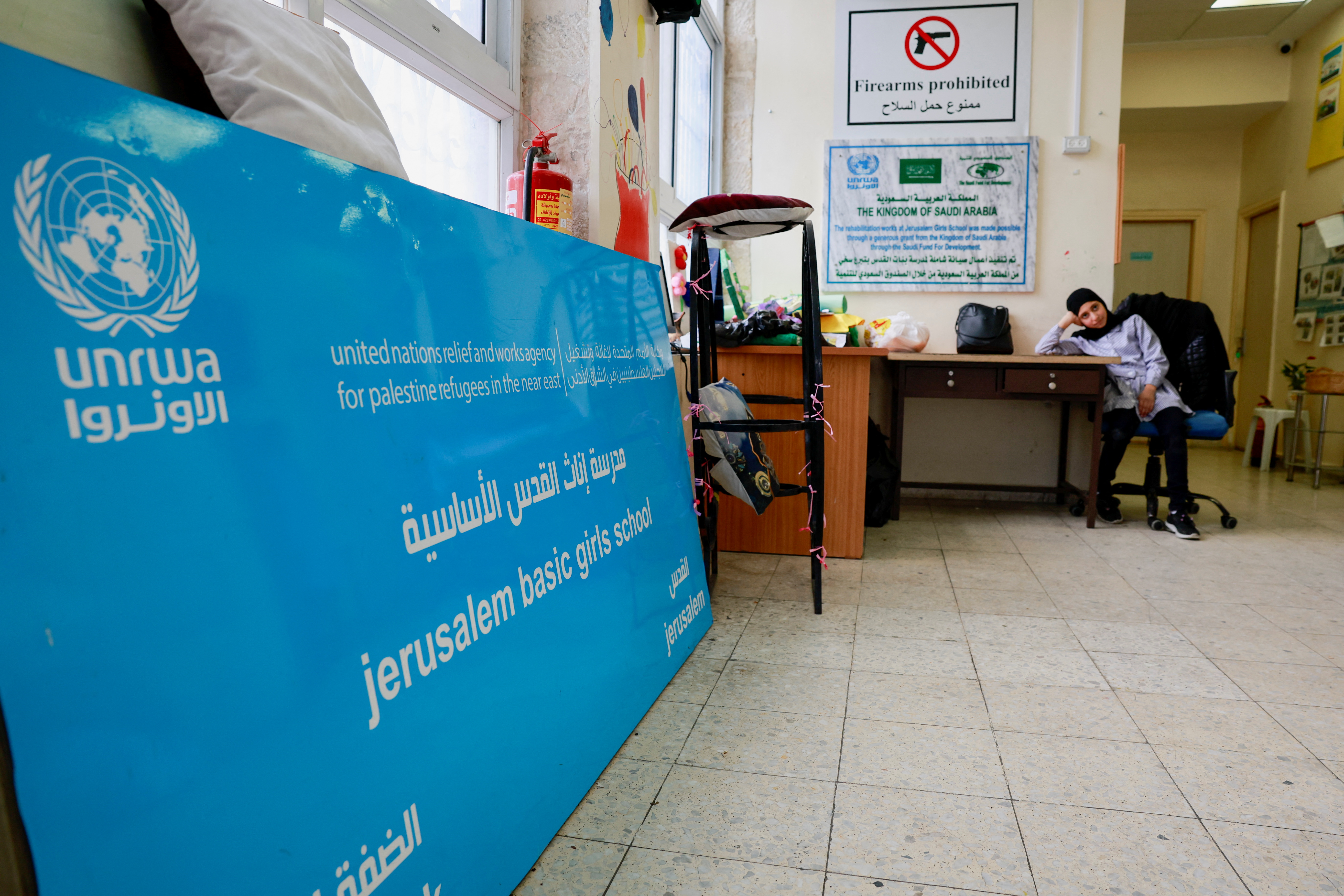 A Palestinian girl waits by the entrance to the UNRWA Jerusalem Girls' School in Silwan, occupied East Jerusalem