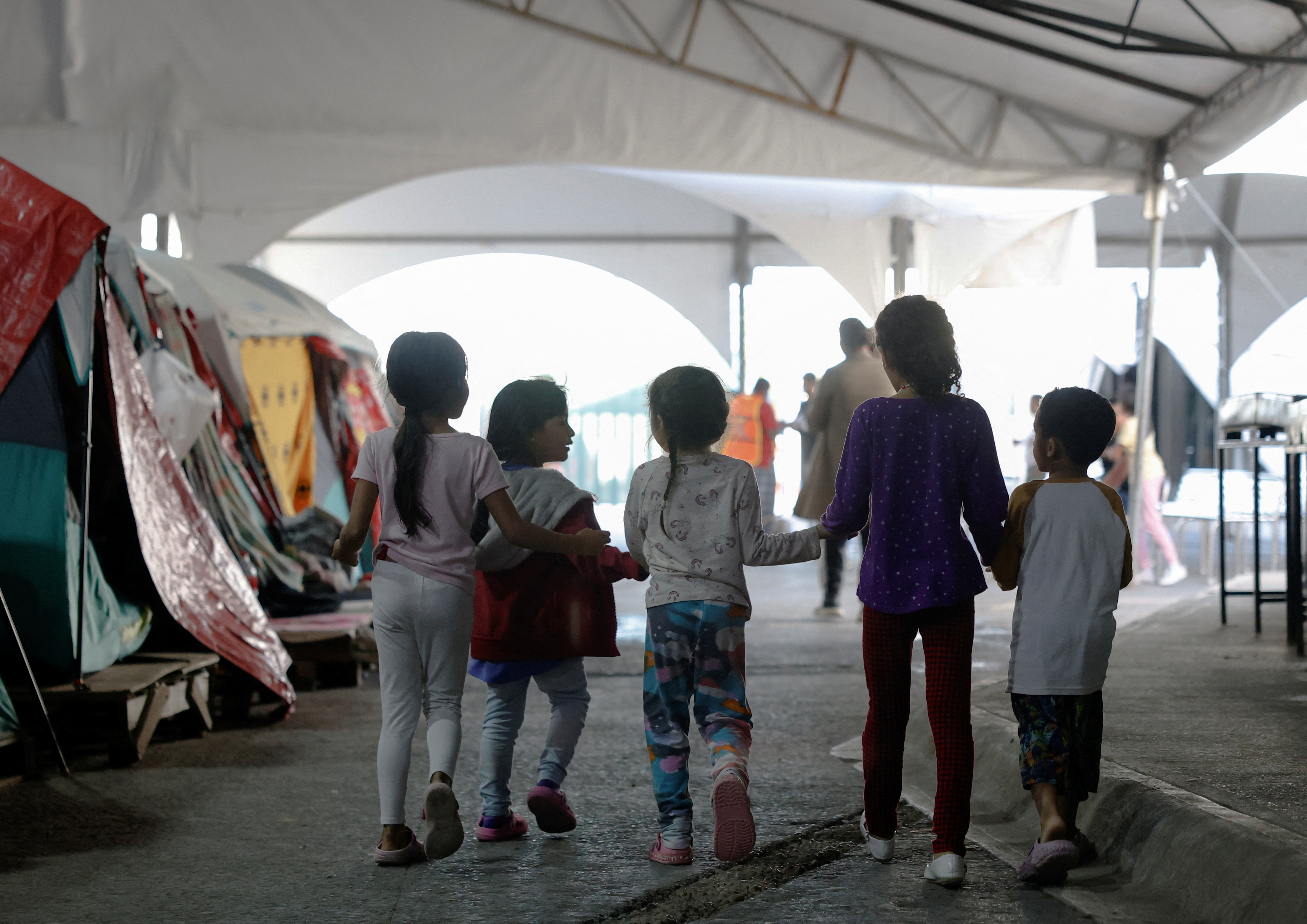 Migrant children seeking asylum with their relatives play as they wait inside a shelter in the hope of getting an appointment with the U.S. Customs and Border Protection (CBP One) ahead of U.S. President-elect Donald Trump's inauguration, in Matamoros, Mexico January 18, 2025. REUTERS/Daniel Becerril