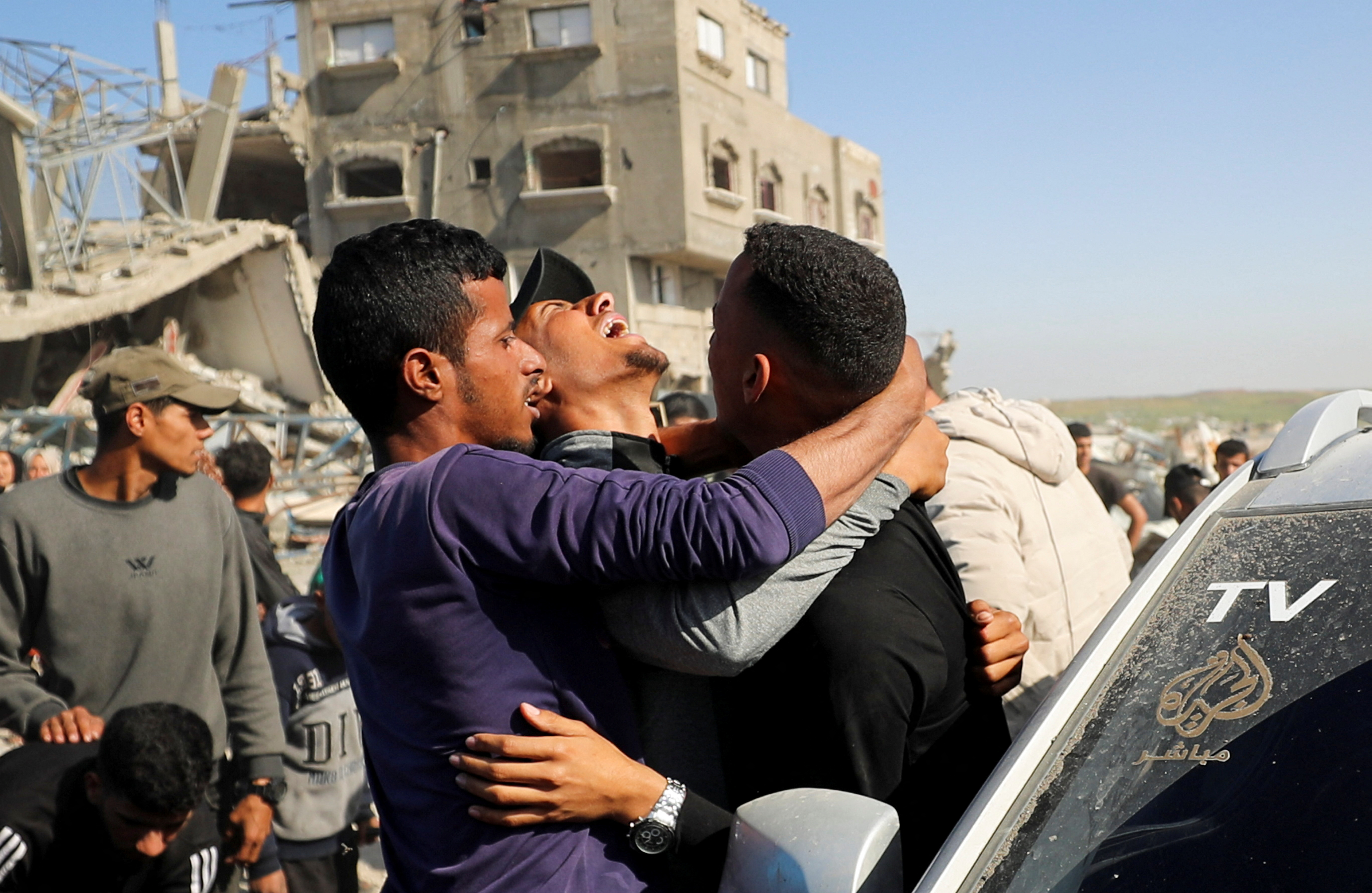 Palestinians react at the site of an Israeli attack.