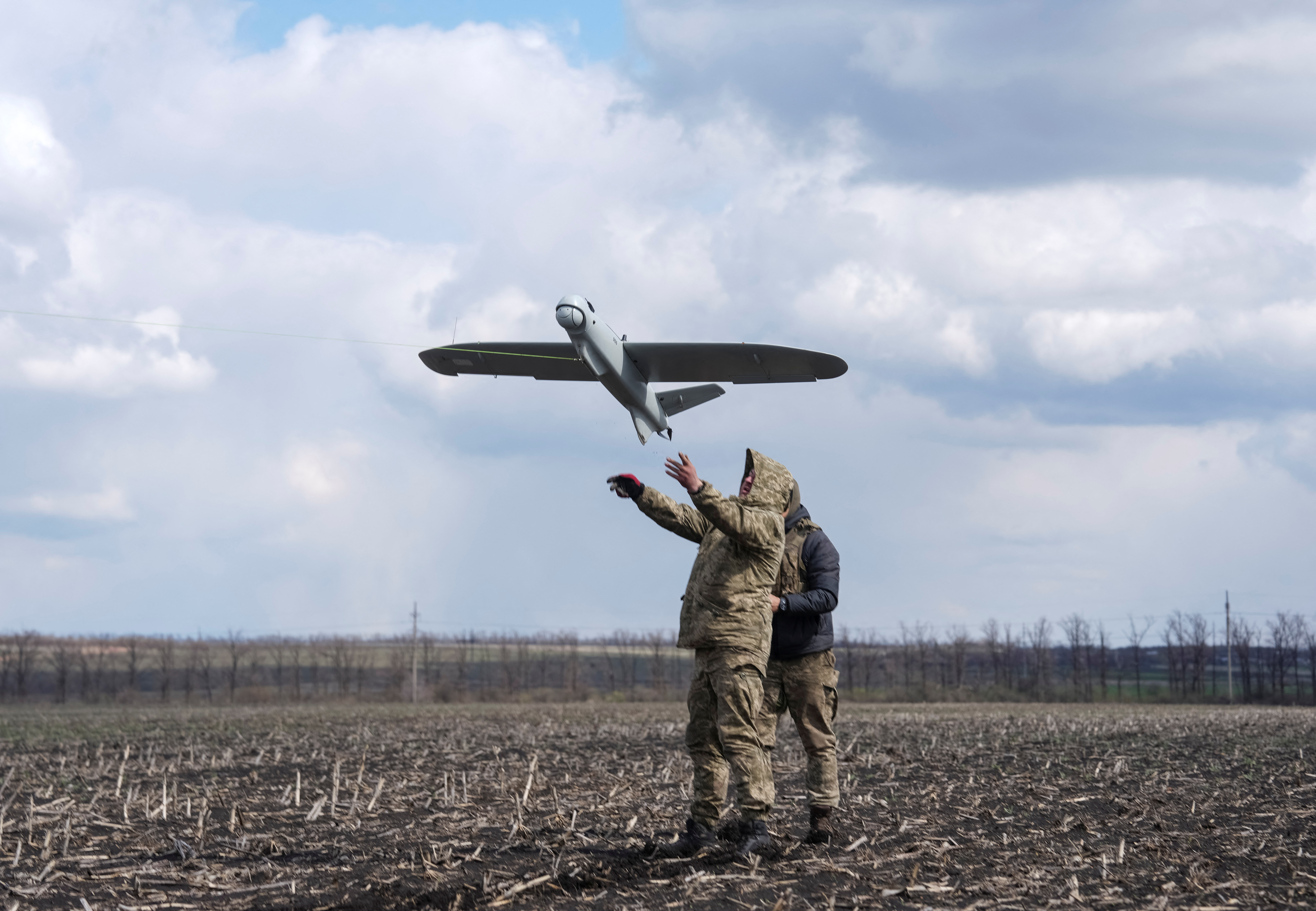Servicemen launch a reconnaissance drone.