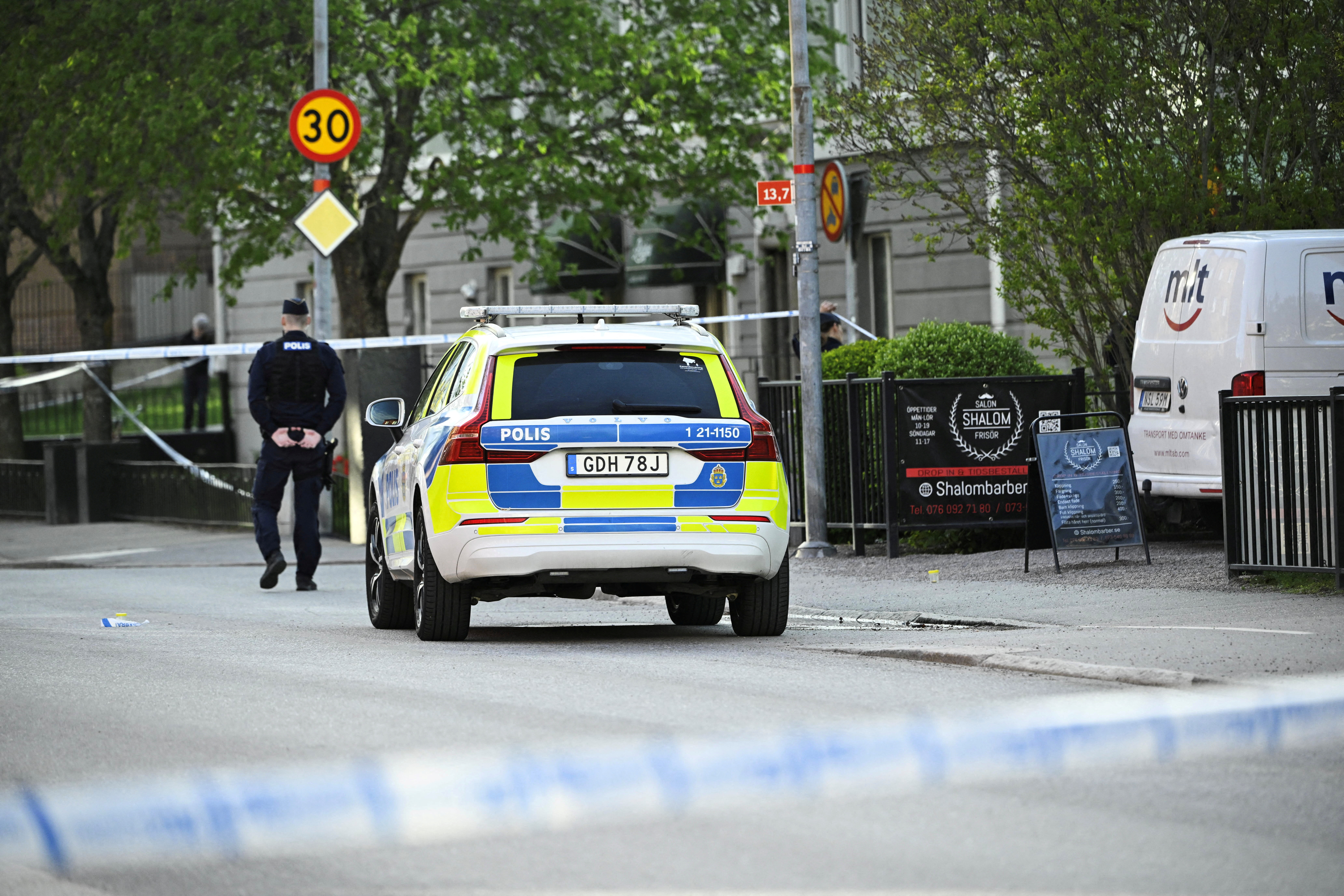 A Swedish police officer works near scene of a shooting in Uppsala