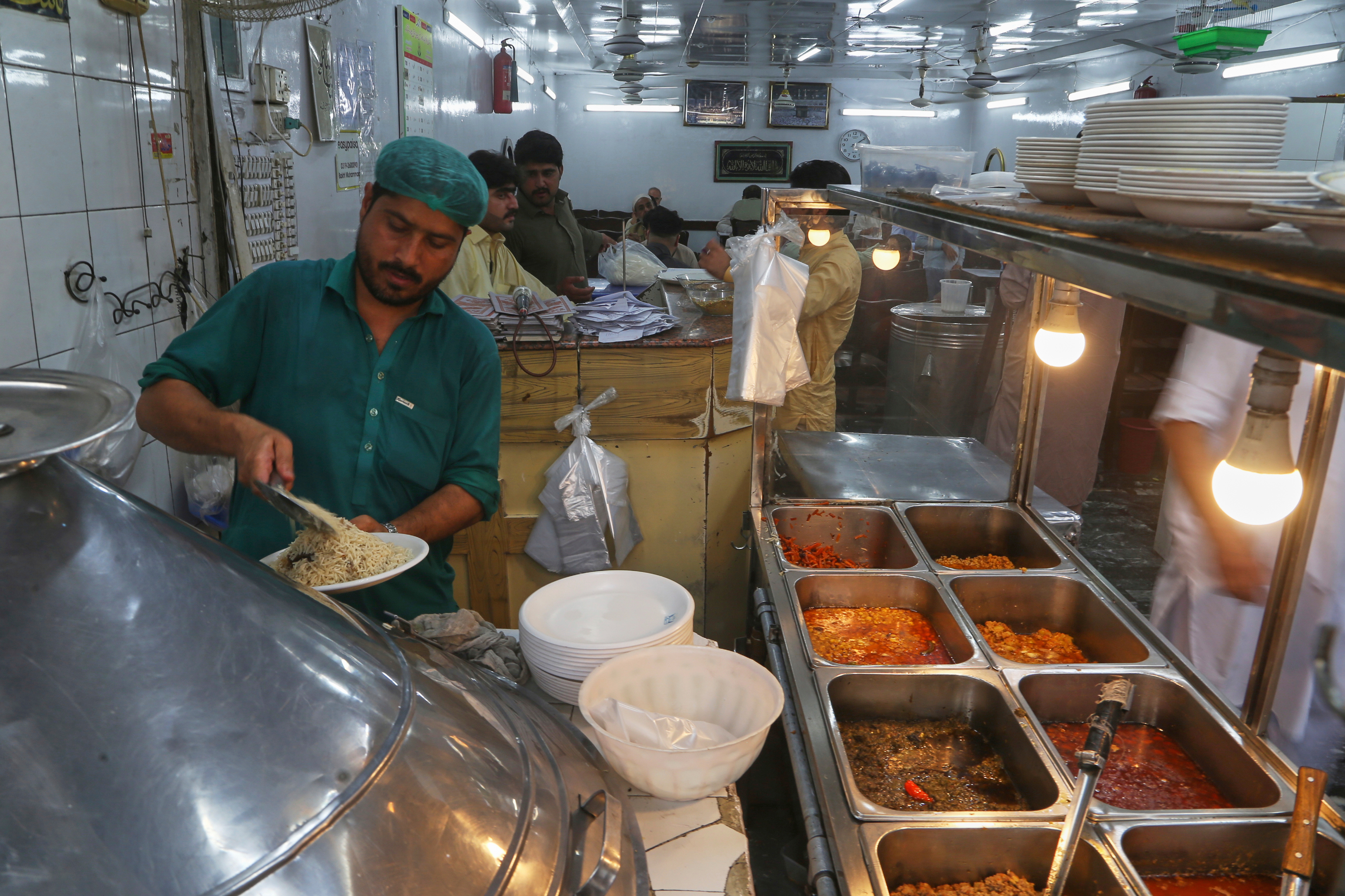 An Afghan cook works in an Afghan restaurant in Peshawar