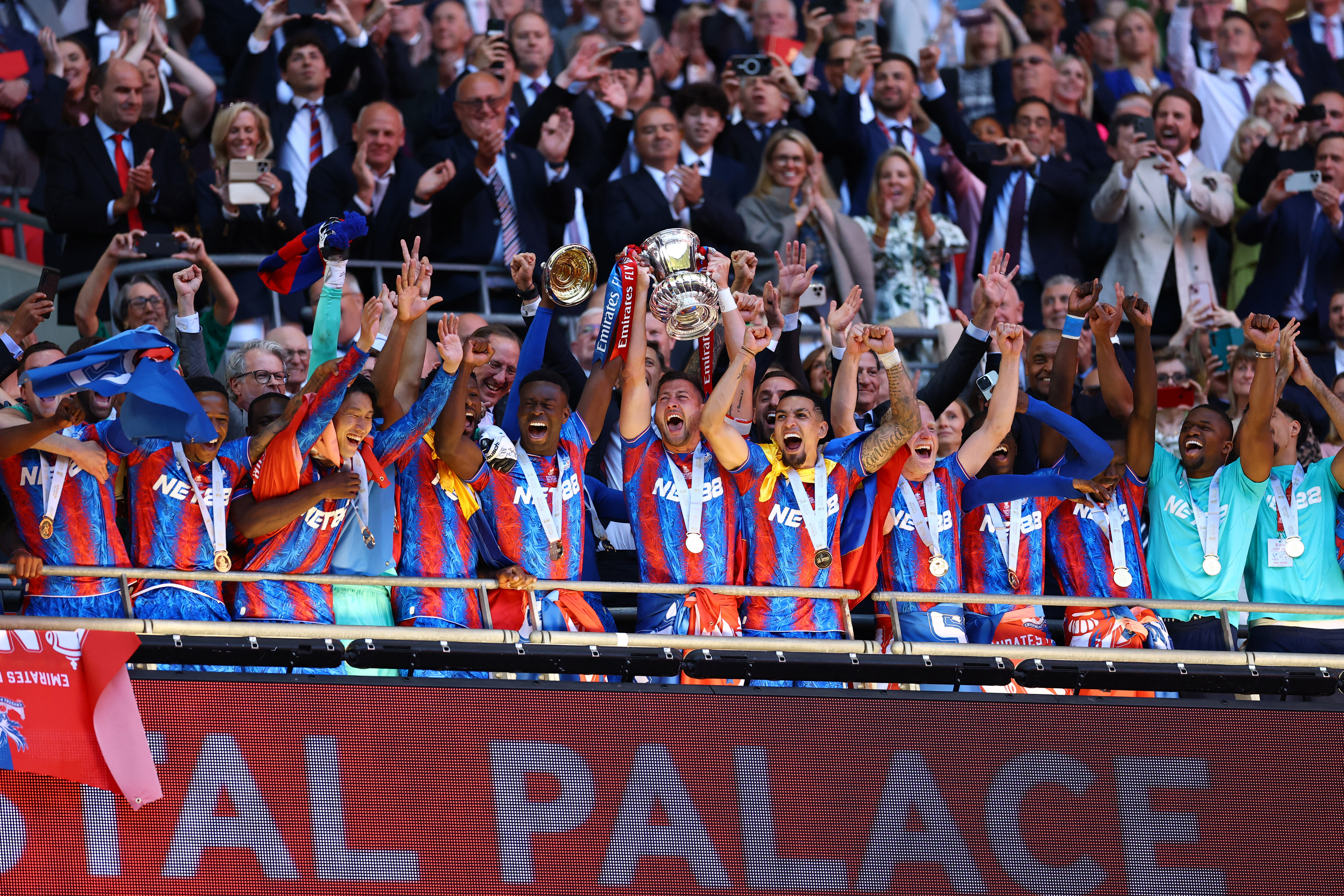 Crystal Palace's Marc Guehi and Joel Ward lift the trophy as they celebrate with teammates after winning the FA Cup
