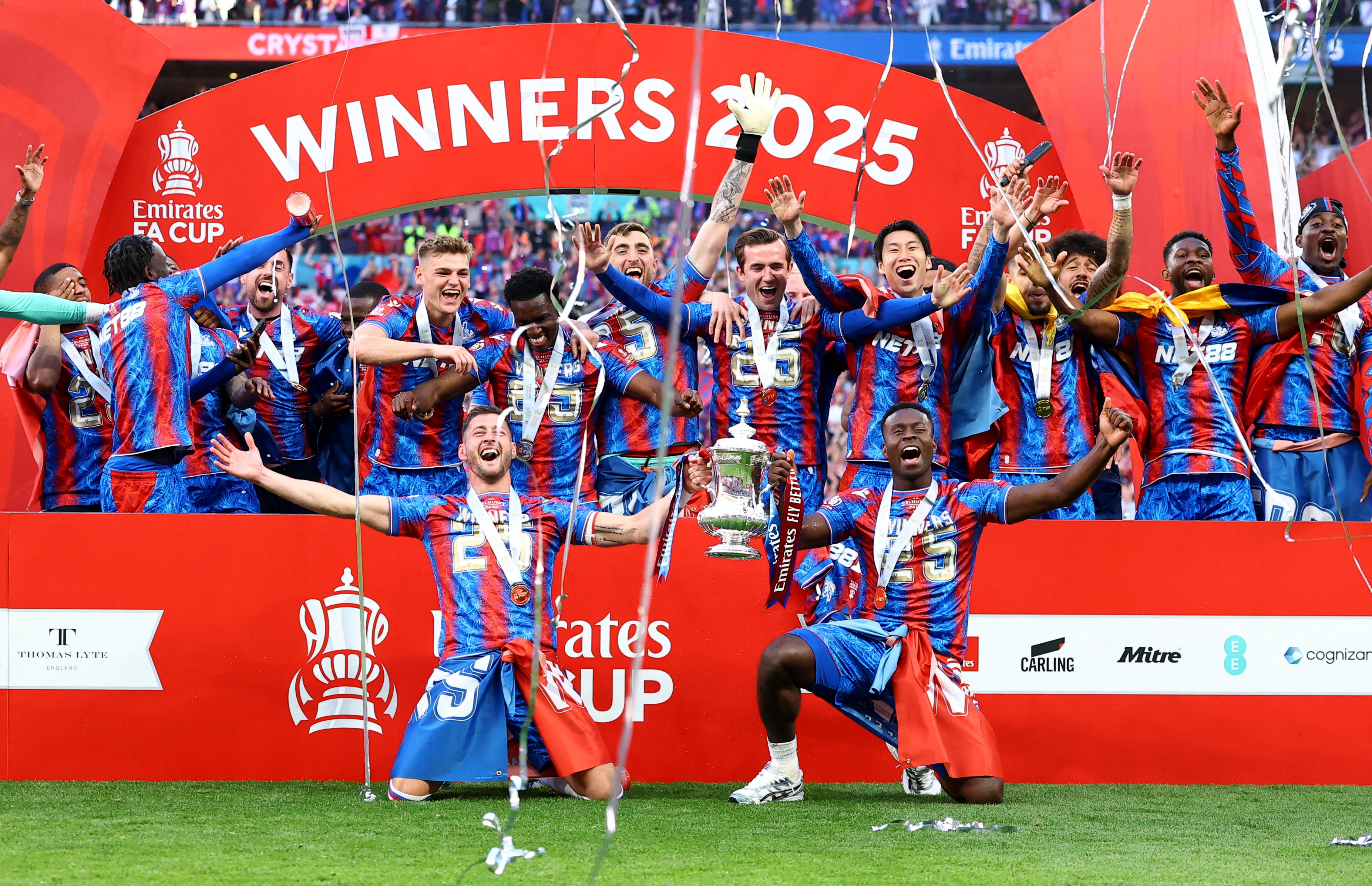 Crystal Palace's Joel Ward and Marc Guehi with the trophy as they celebrate with teammates after winning the FA Cup