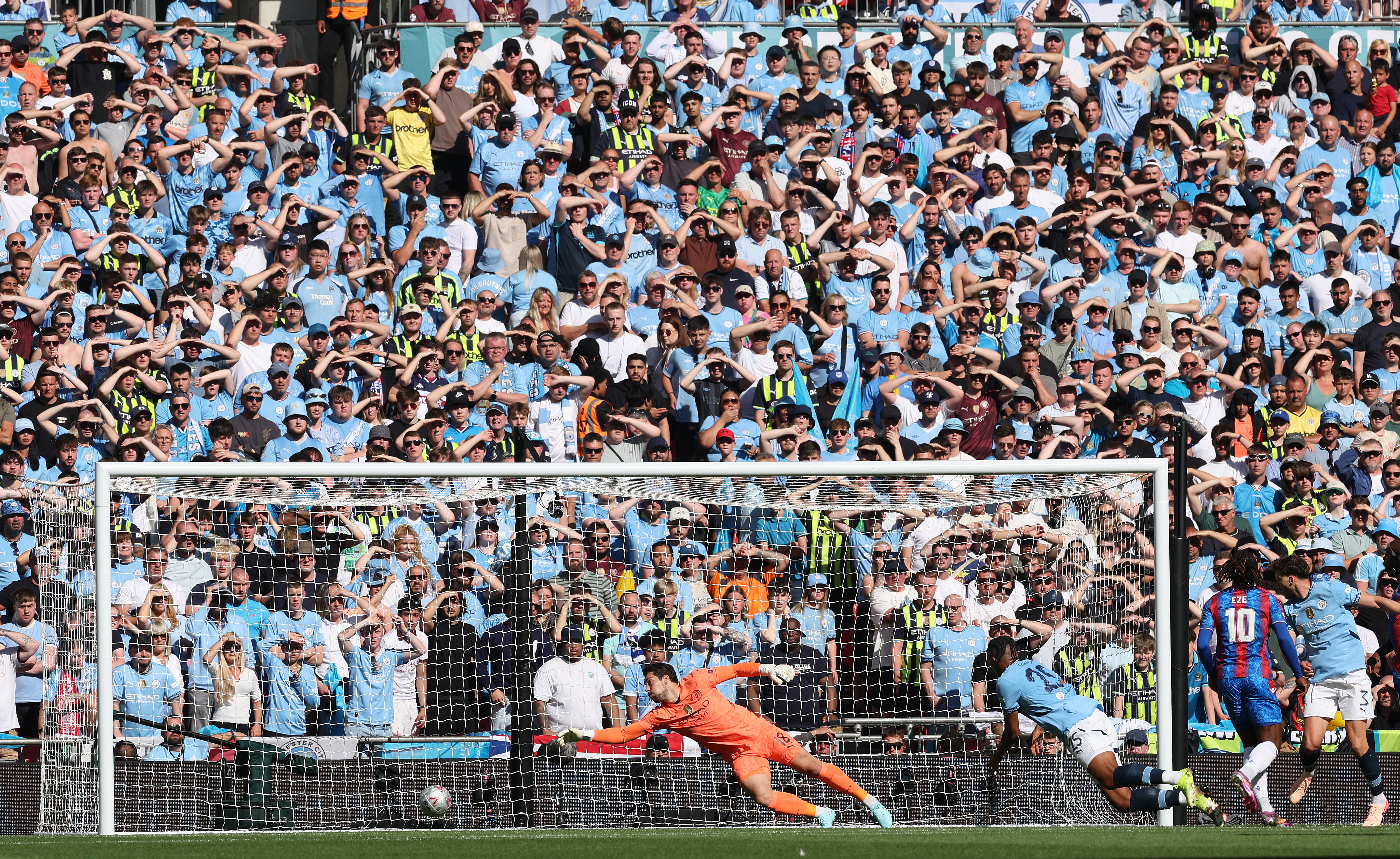 Crystal Palace's English midfielder #10 Eberechi Eze (R) watches his shot into the net as he scores the opening goal during the English FA Cup final football match between Crystal Palace and Manchester City at Wembley stadium in London, on May 17, 2025. (Photo by Adrian Dennis / AFP) / NOT FOR MARKETING OR ADVERTISING USE / RESTRICTED TO EDITORIAL USE