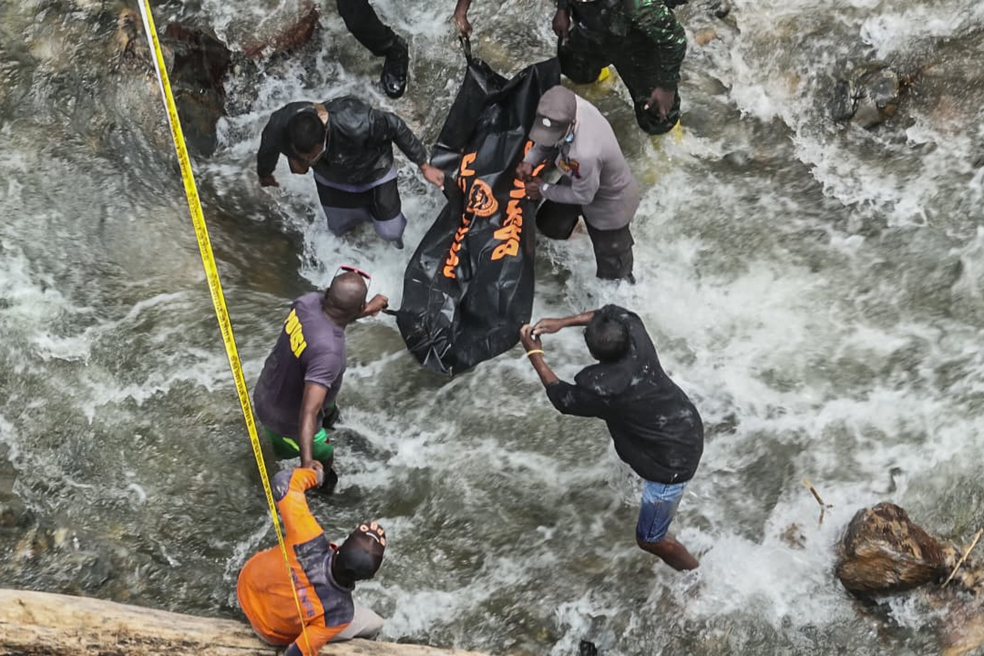 rescuers recovering bodies after hours of heavy rain triggered flooding and a landslide near a gold mine in a remote area near Manokwari, West Papua