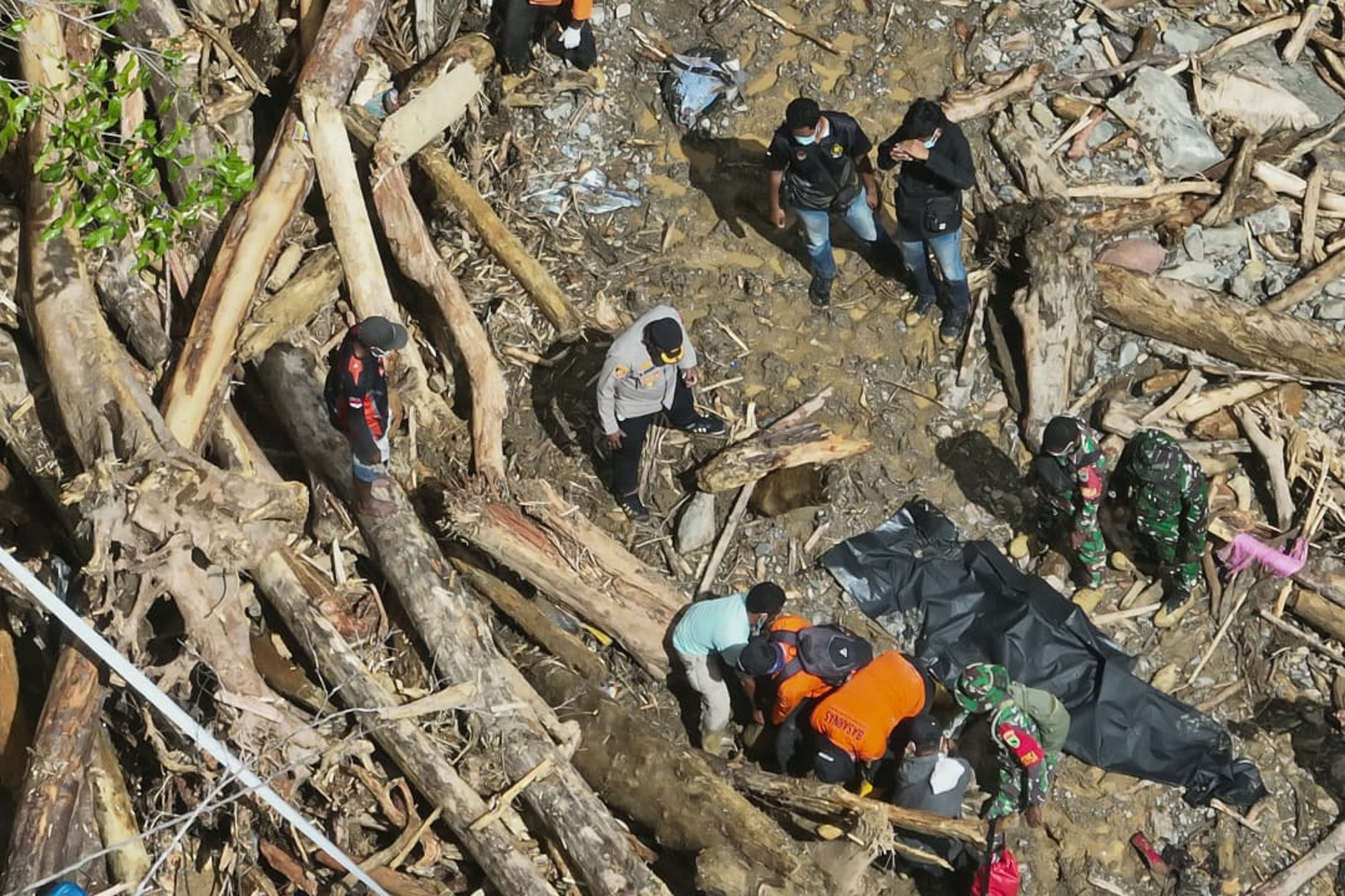 rescuers recovering bodies after hours of heavy rain triggered flooding and a landslide near a gold mine in a remote area near Manokwari, West Papua