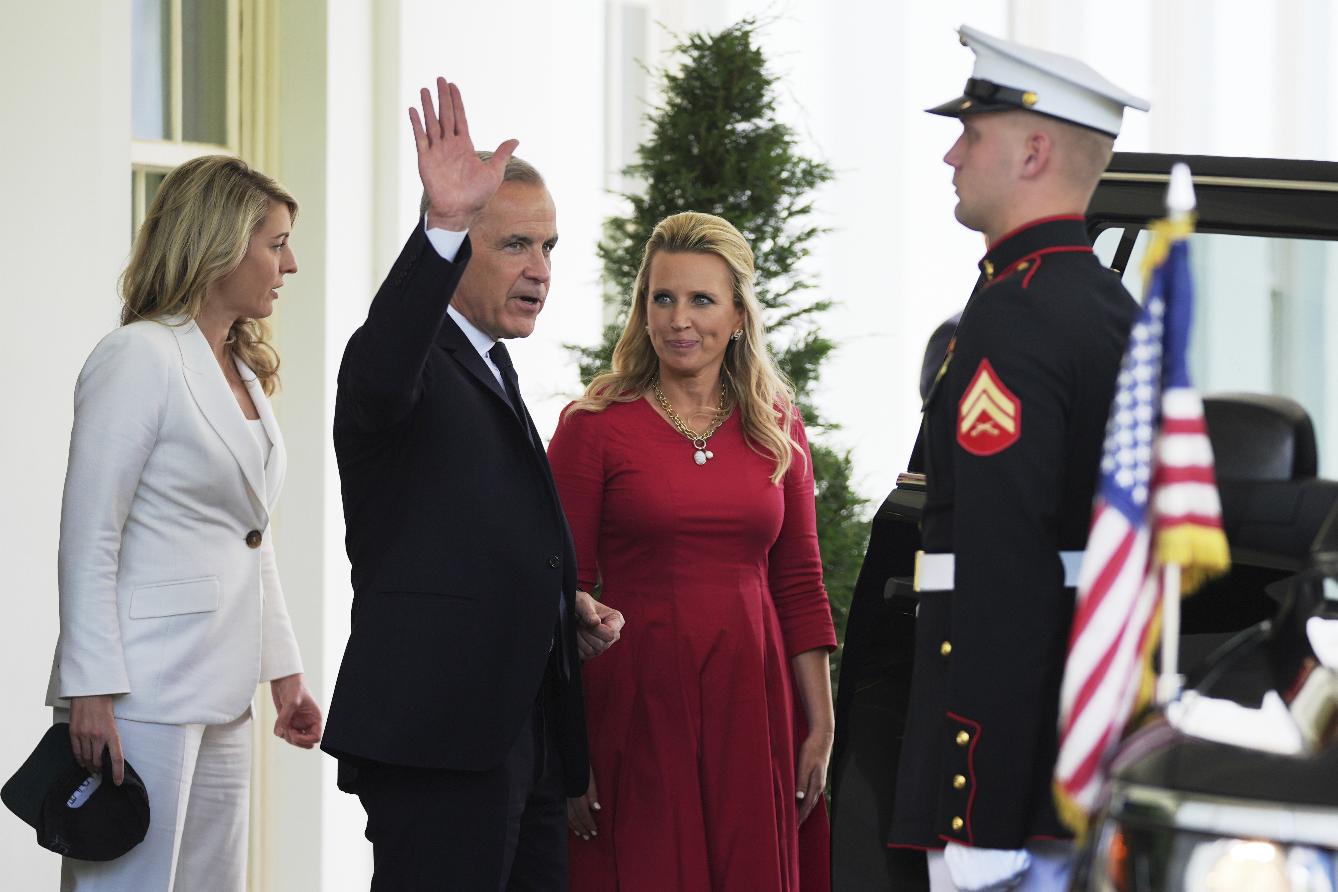 Canadian Prime Minister Mark Carney waves as he departs the White House