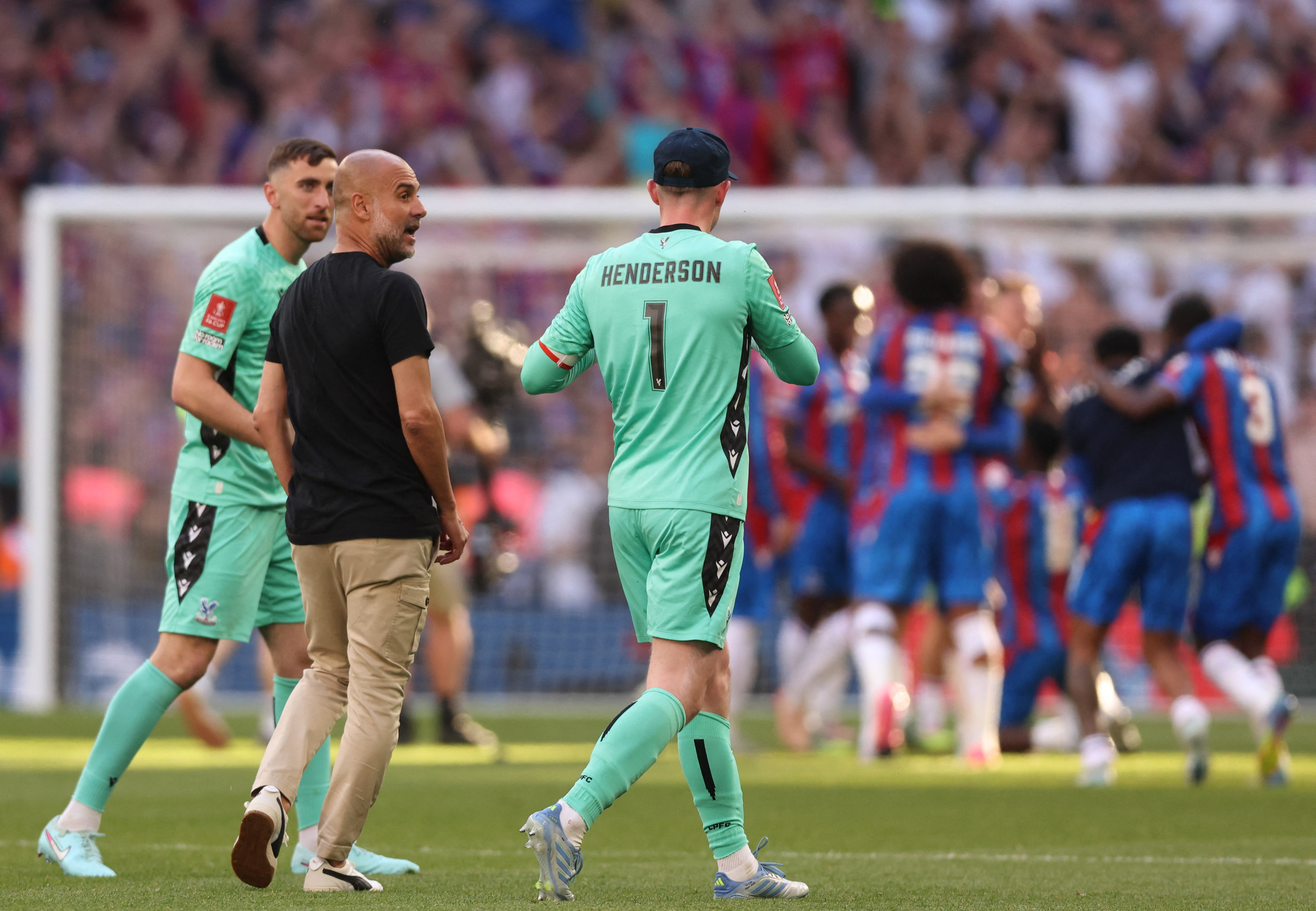 FA Cup - Final - Crystal Palace v Manchester City - Wembley Stadium, London, Britain - May 17, 2025 Manchester City manager Pep Guardiola with Crystal Palace's Dean Henderson and teammates after Crystal Palace won the FA Cup