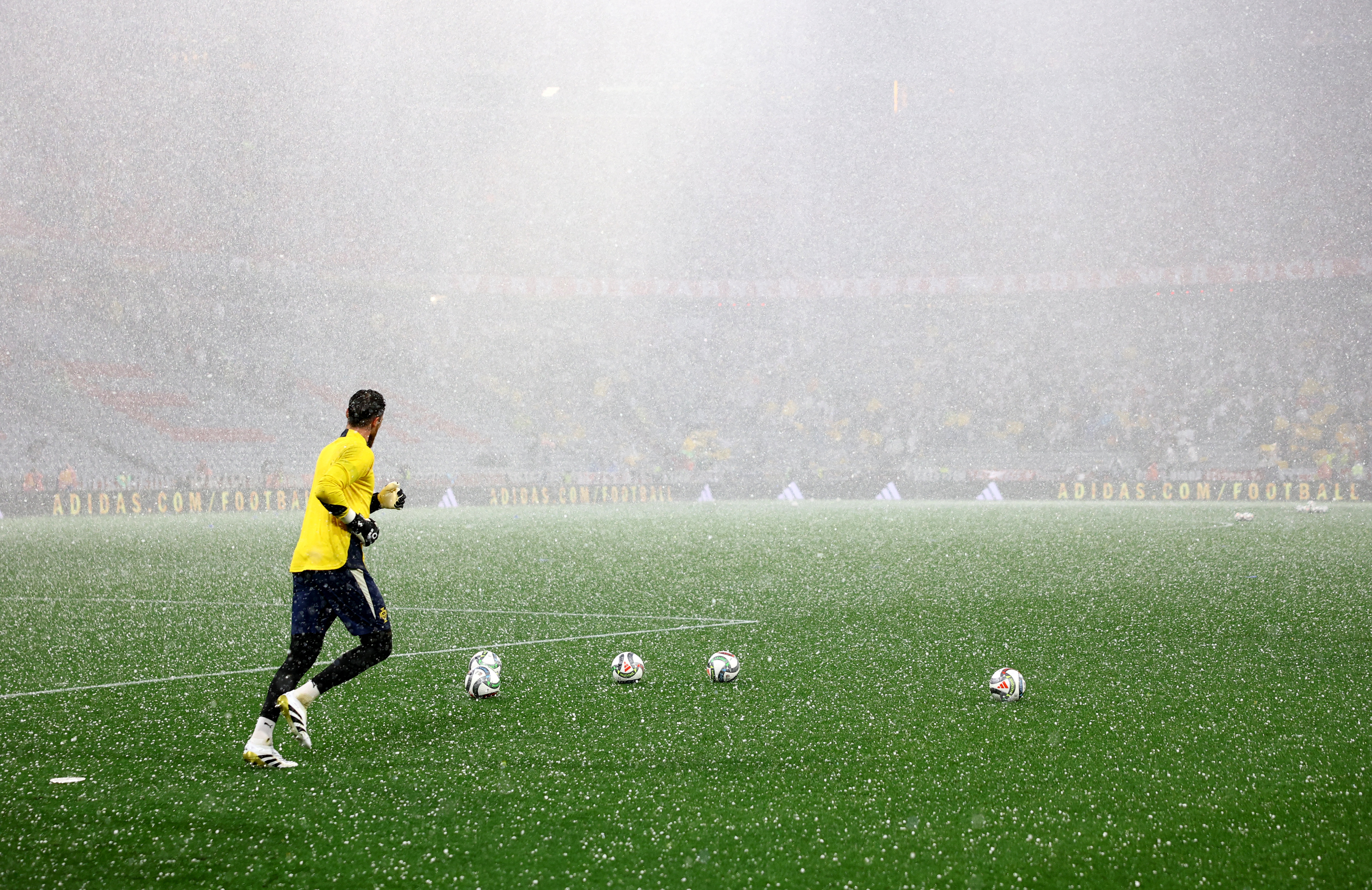 Portugal's Jose Sa during the warm up as hail stones are seen falling on the pitch before the match