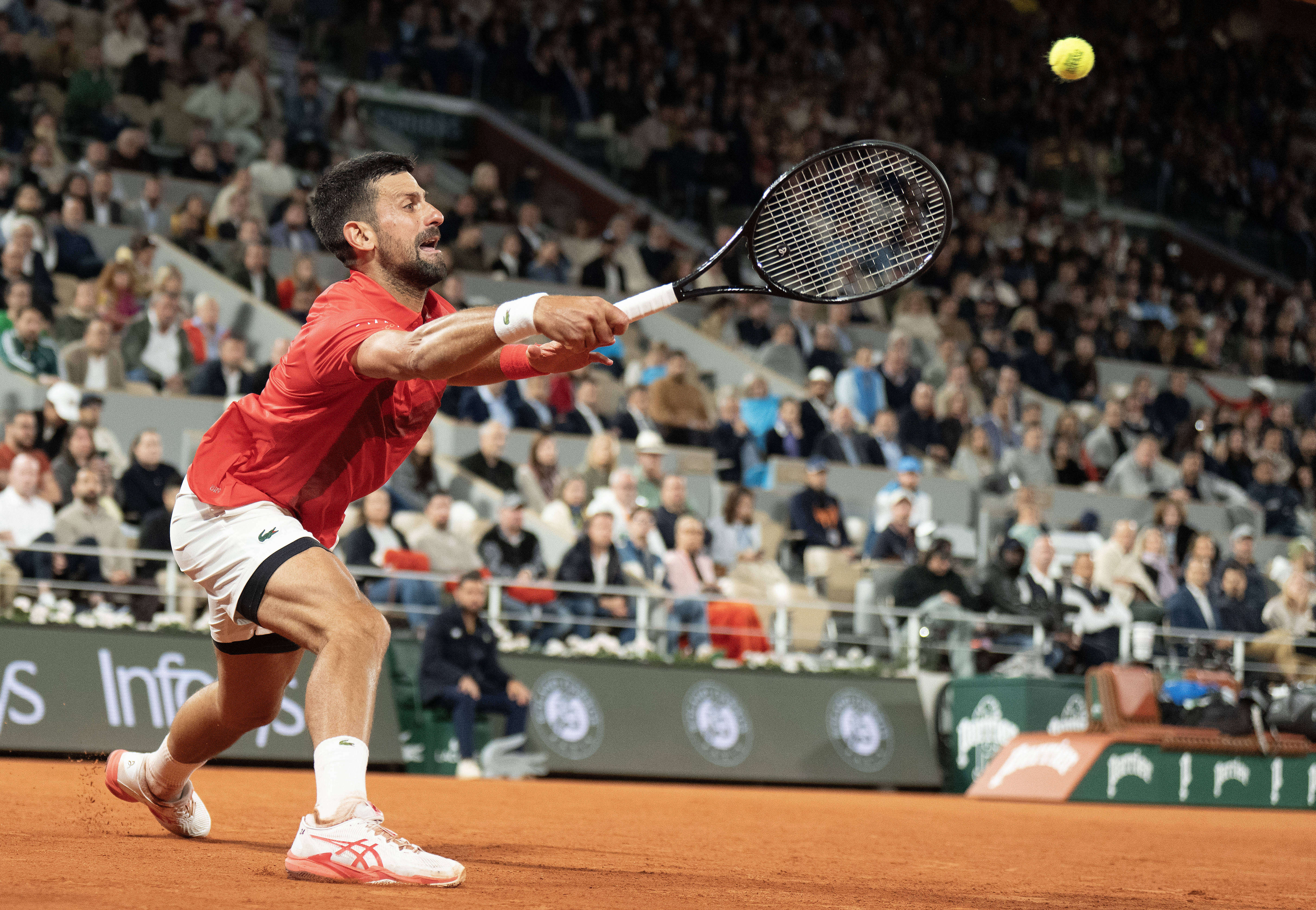 Novak Djokovic of Serbia returns a shot during his match against Alexander Zverev of Germany on day 11 at Roland Garros Stadium