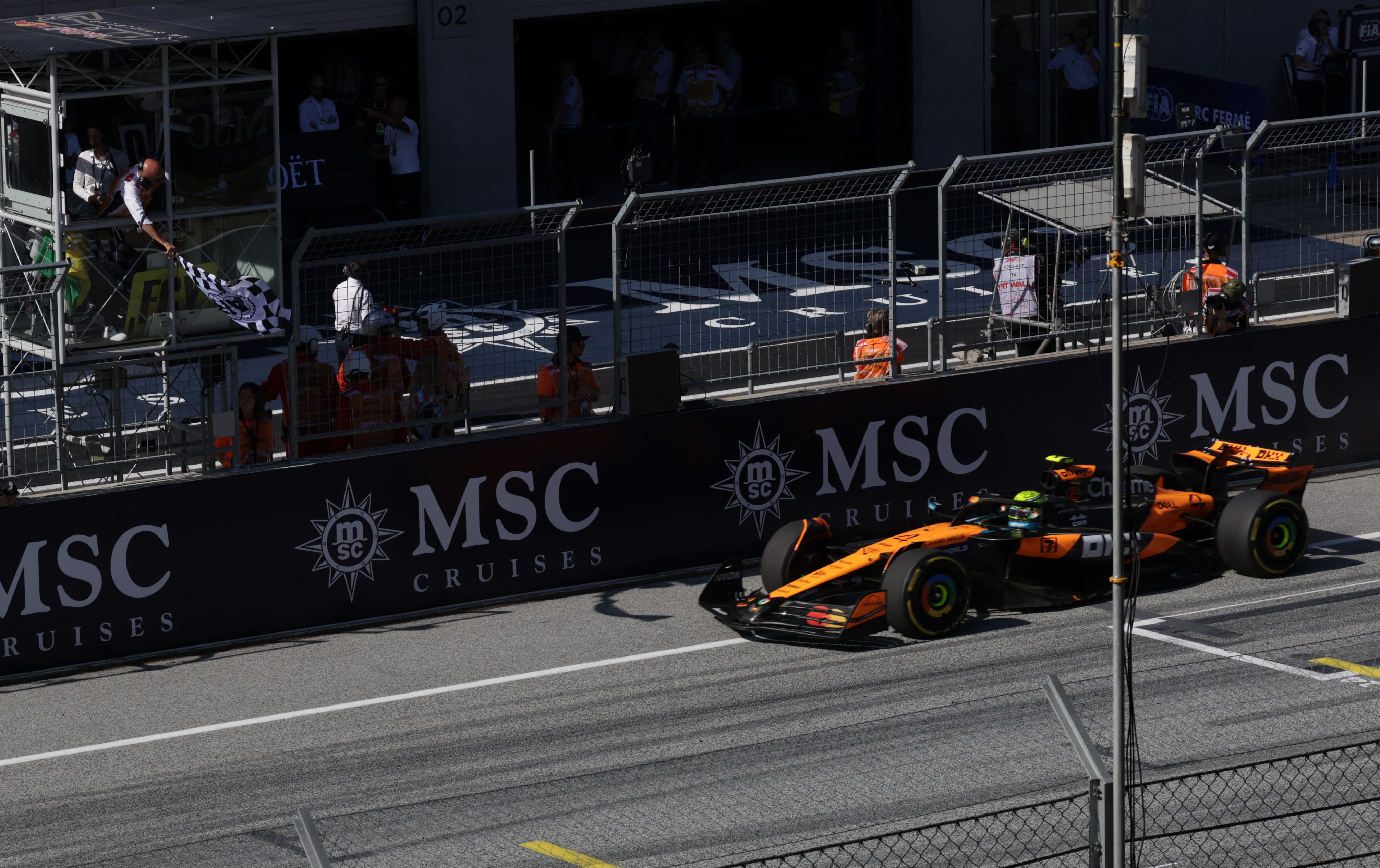 Lando Norris crosses finish line.