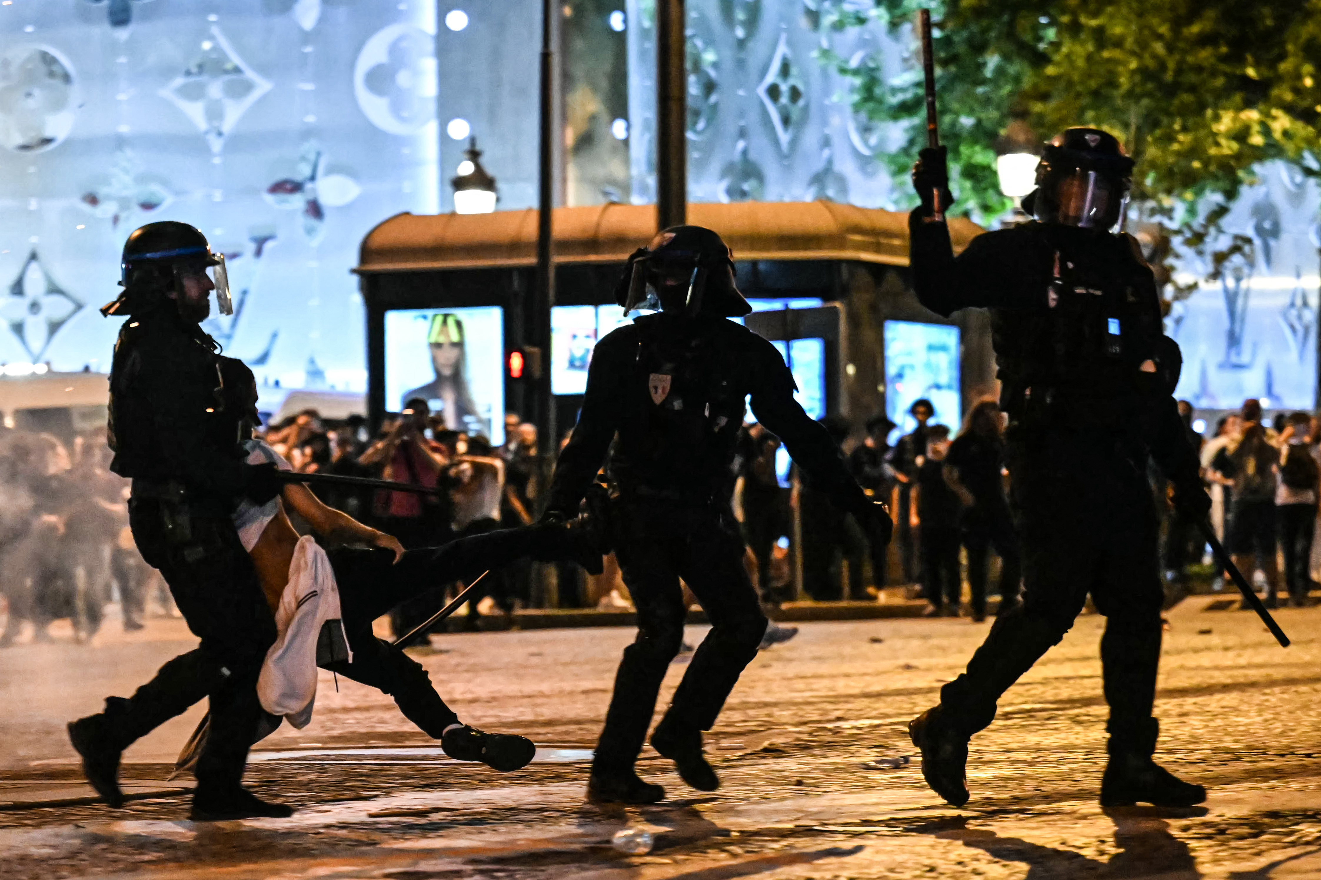 Anti-riot police officers detain a person in Paris.