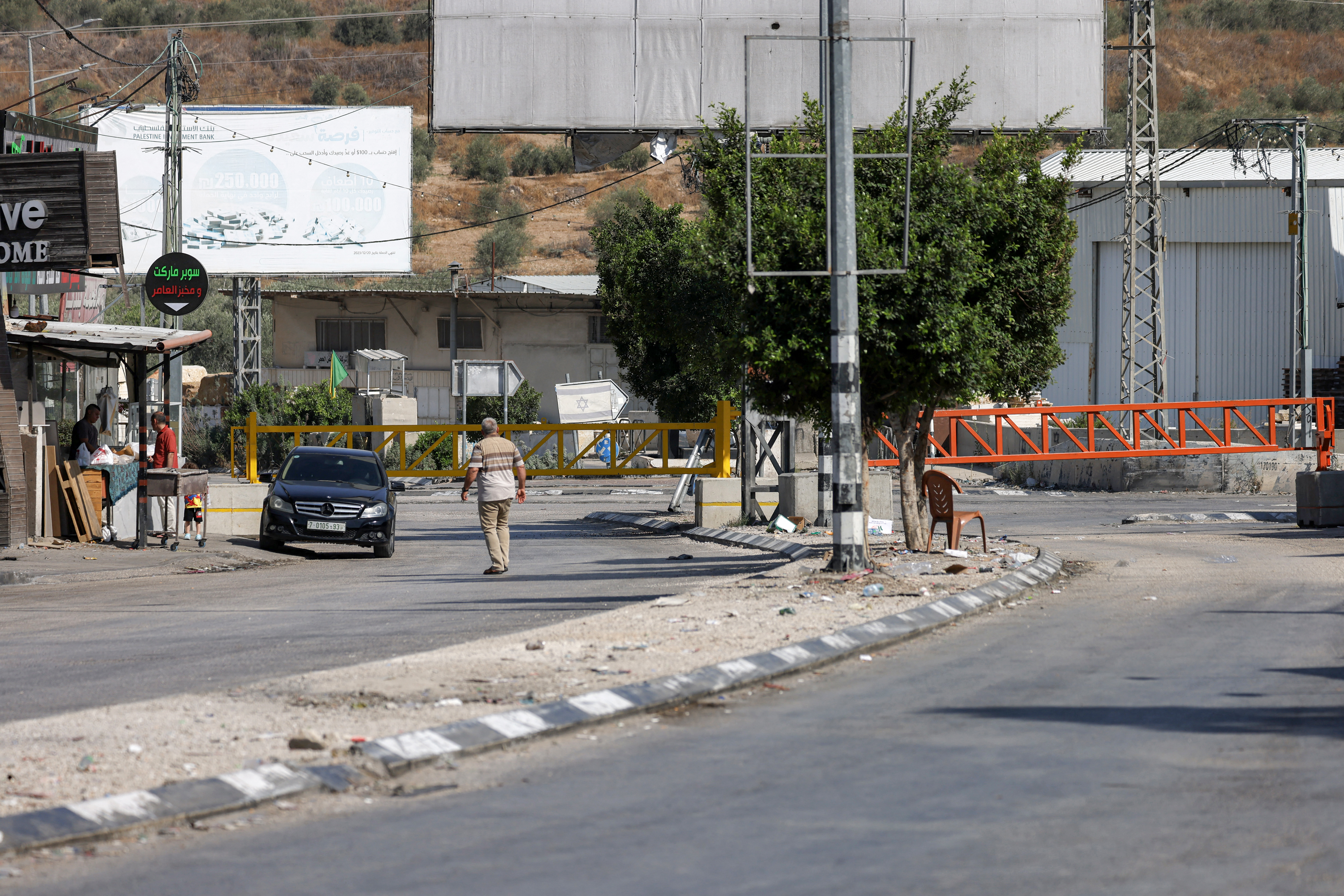 The gates of an Israeli checkpoint are closed to vehicles in Deir Sharaf, west of Nablus, in the occupied West Bank on June 13, 2025. (Photo by JAAFAR ASHTIYEH / AFP)