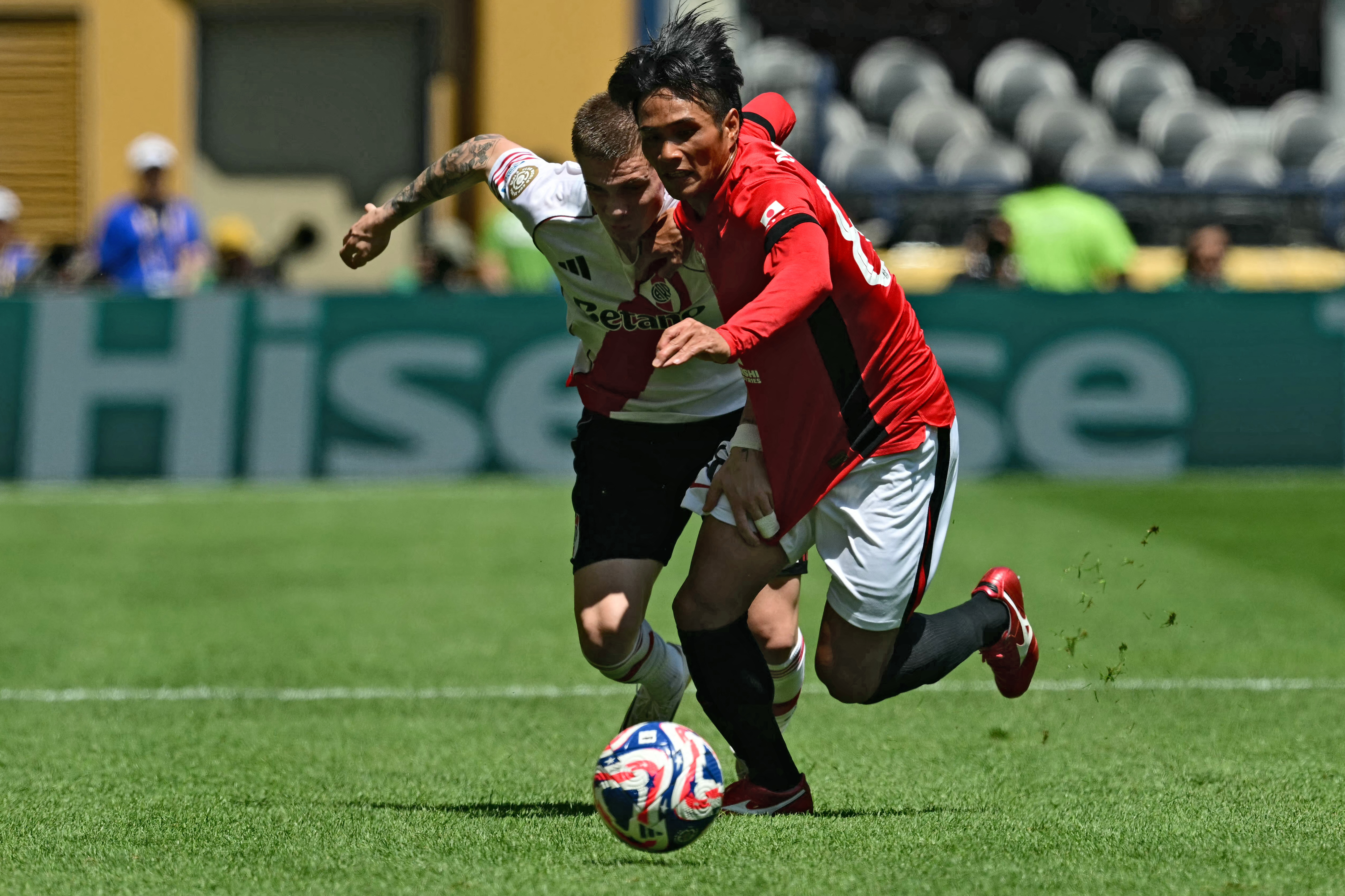 Urawa Red Diamonds' Japanese midfielder #88 Yoichi Naganuma (R) fights for the ball with River Plate's Argentine midfielder #30 Franco Mastantuono during the FIFA Club World Cup 2025 Group E football match between Argentina's River Plate and Japan's Urawa Red Diamonds at the Lumen Field stadium in Seattle on June 17, 2025. (Photo by Pablo PORCIUNCULA / AFP)