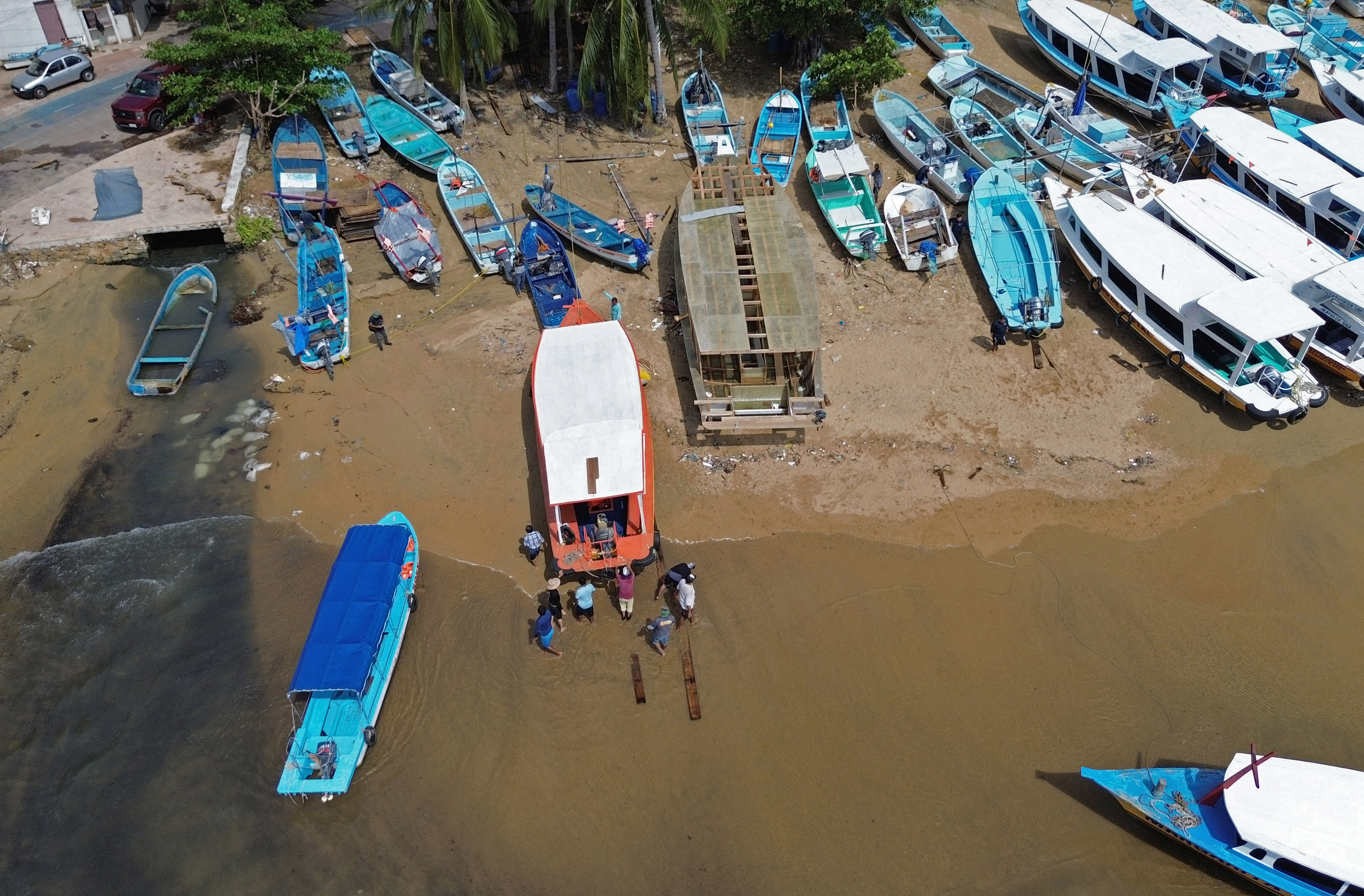 Boats are taken out from the sea as preparations are made for the arrival of Hurricane Erick at Manzanillo Beach in Acapulco, Guerrero State