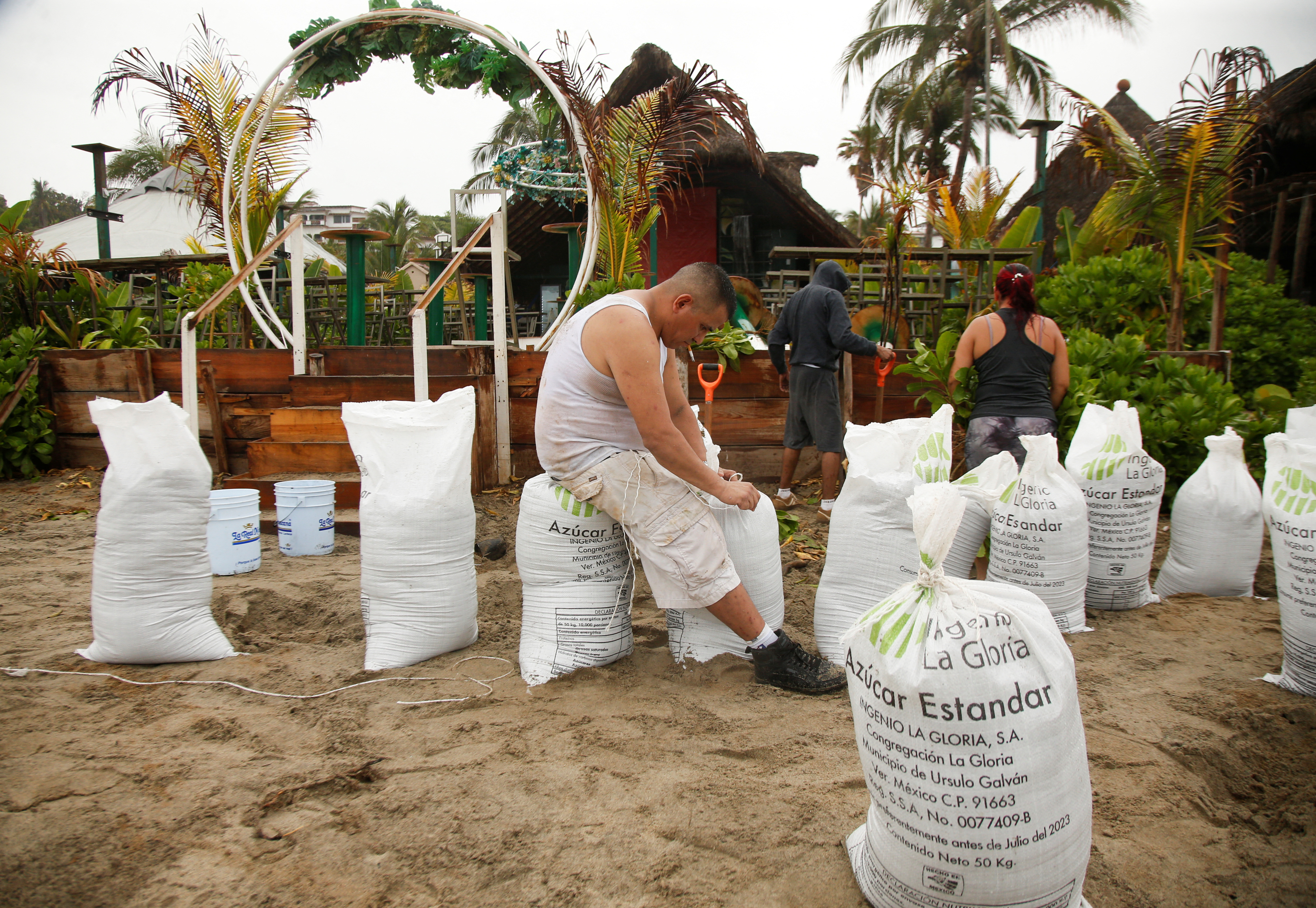 A man ties a sandbag before Hurricane Erick’s arrival in Puerto Escondido, Oaxaca state, Mexico, on June 18, 2025