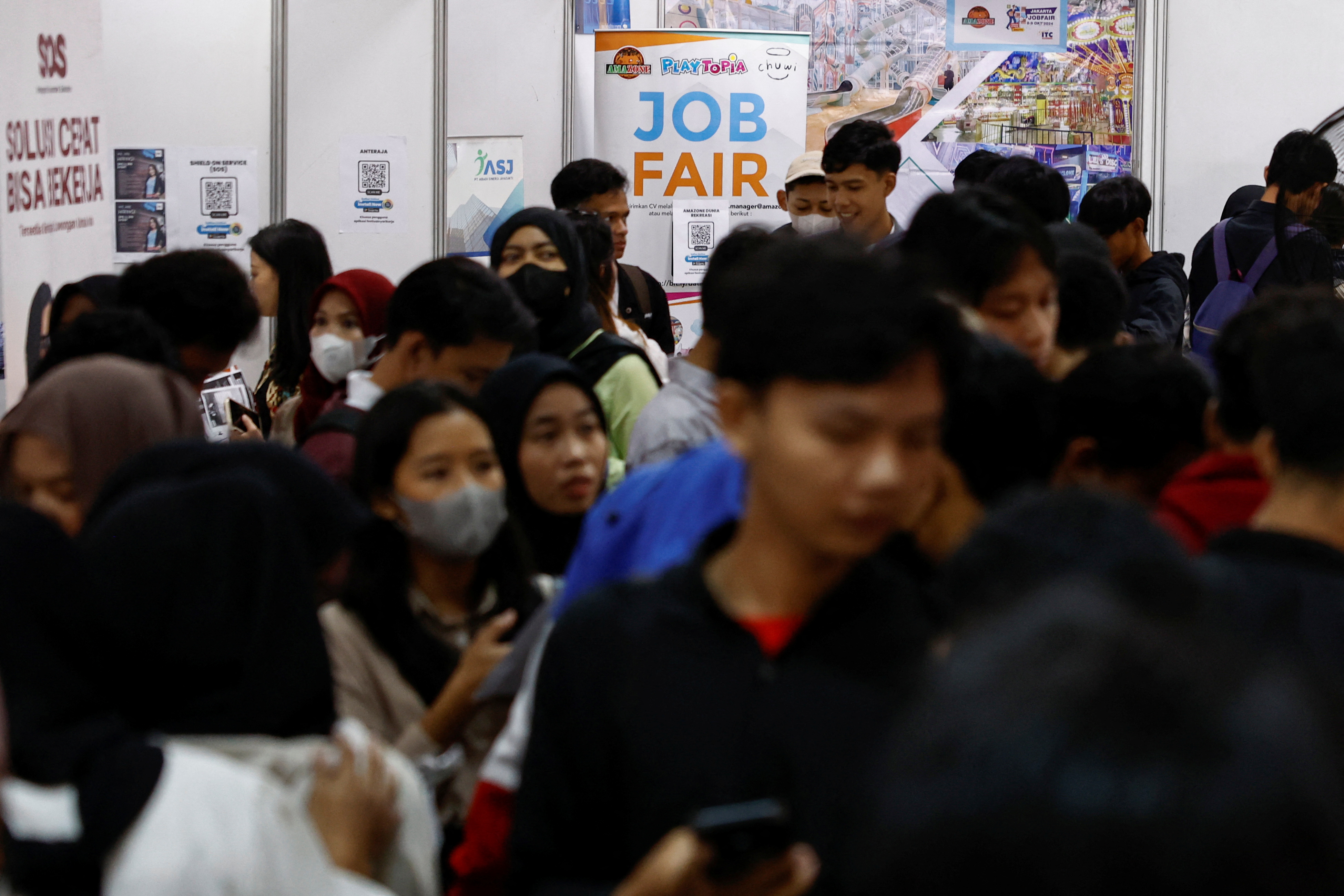 Job seekers attend a job fair.