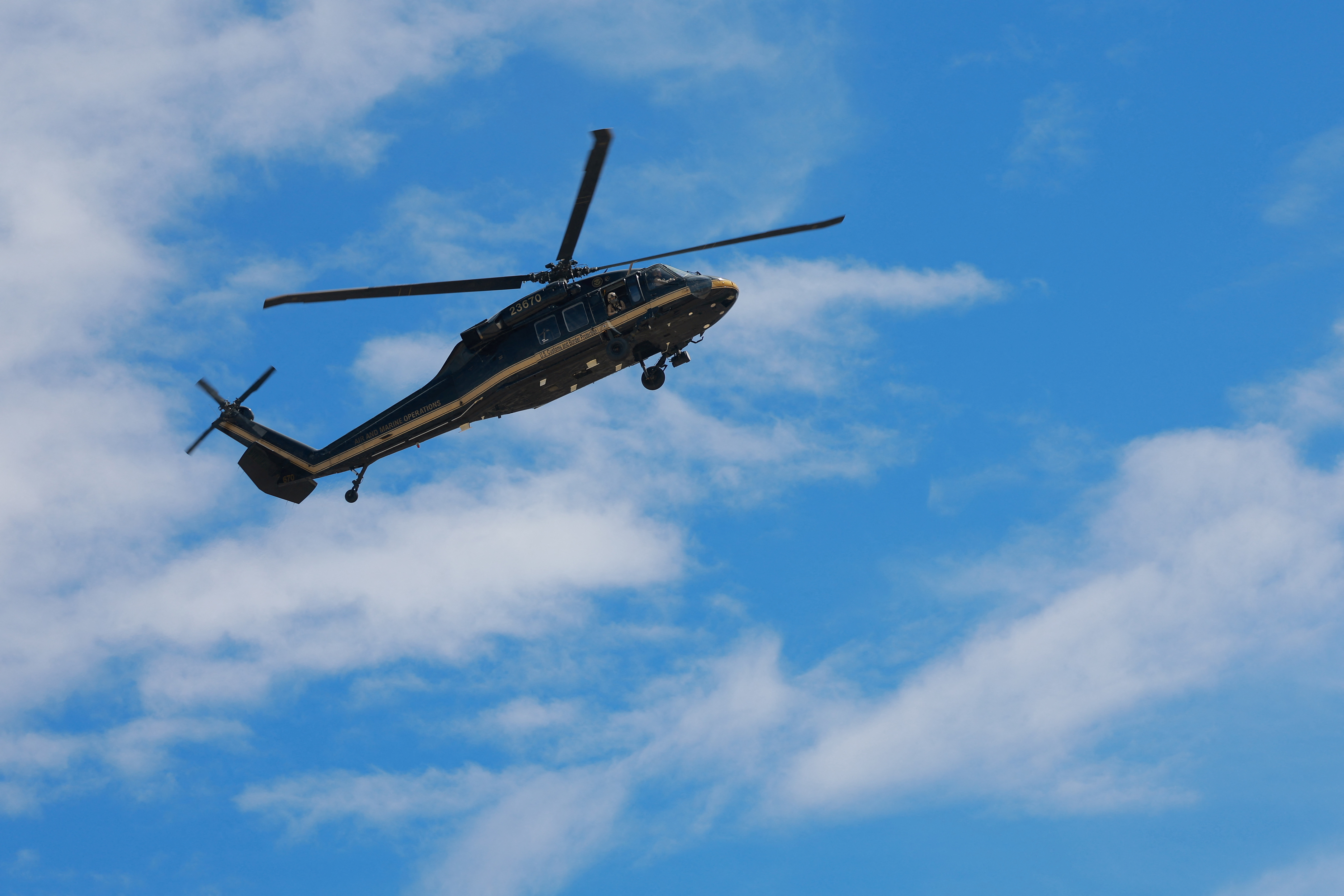 A CBP Air and Marine Operations helicopter conducts surveillance along the U.S.-Mexico border, as seen from Ciudad Juarez, Mexico, July 23, 2025. REUTERS/Jose Luis Gonzalez