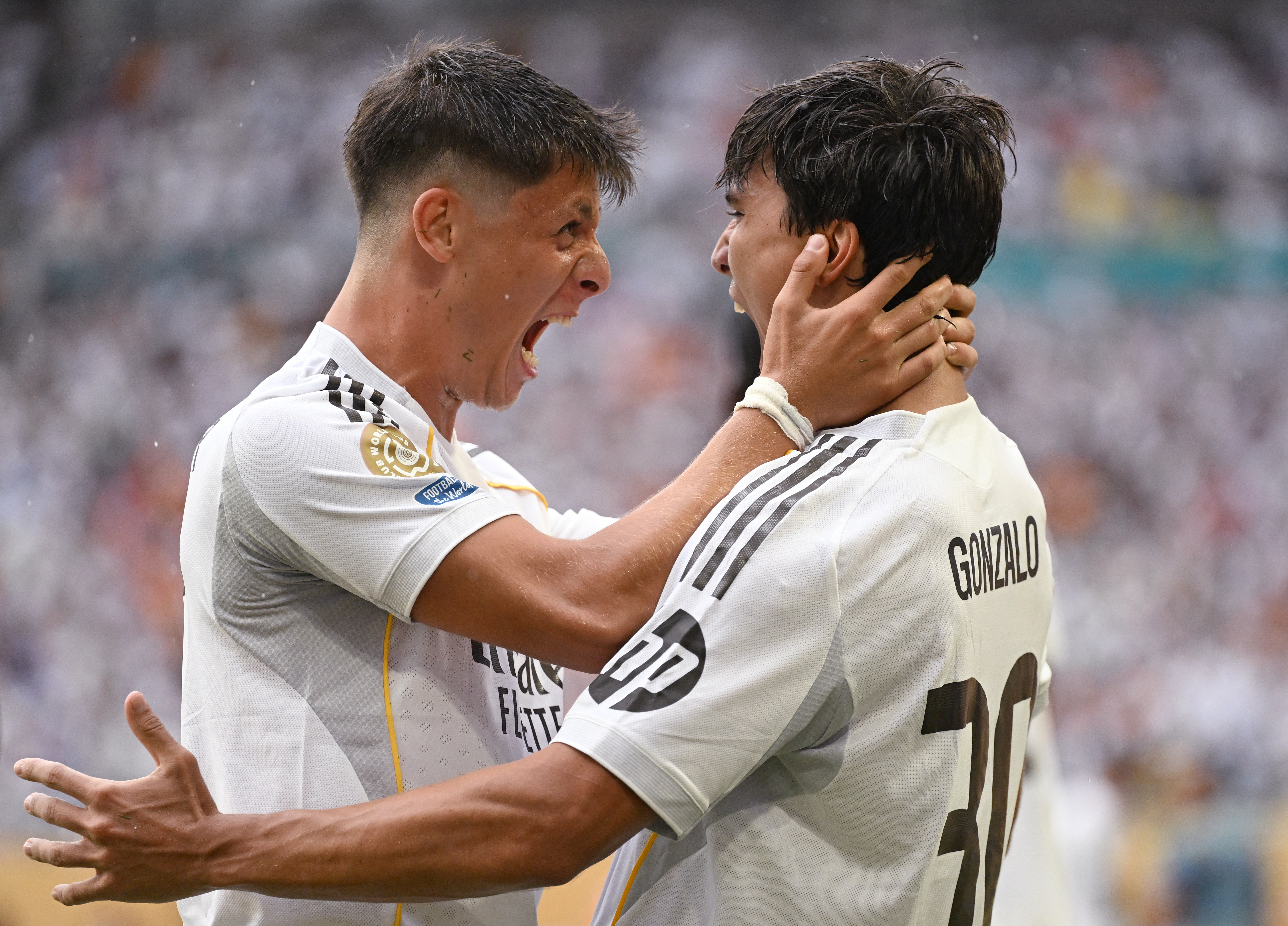 Real Madrid's Spanish forward #30 Gonzalo Garcia (R) celebrates with teammate Real Madrid's Turkish midfielder #15 Arda Guler (L) after scoring the opening goal during the FIFA Club World Cup 2025 round of 16 football match between Spain's Real Madrid and Italy's Juventus at the Hard Rock Stadium in Miami on July 1, 2025. (Photo by Patricia DE MELO MOREIRA / AFP)