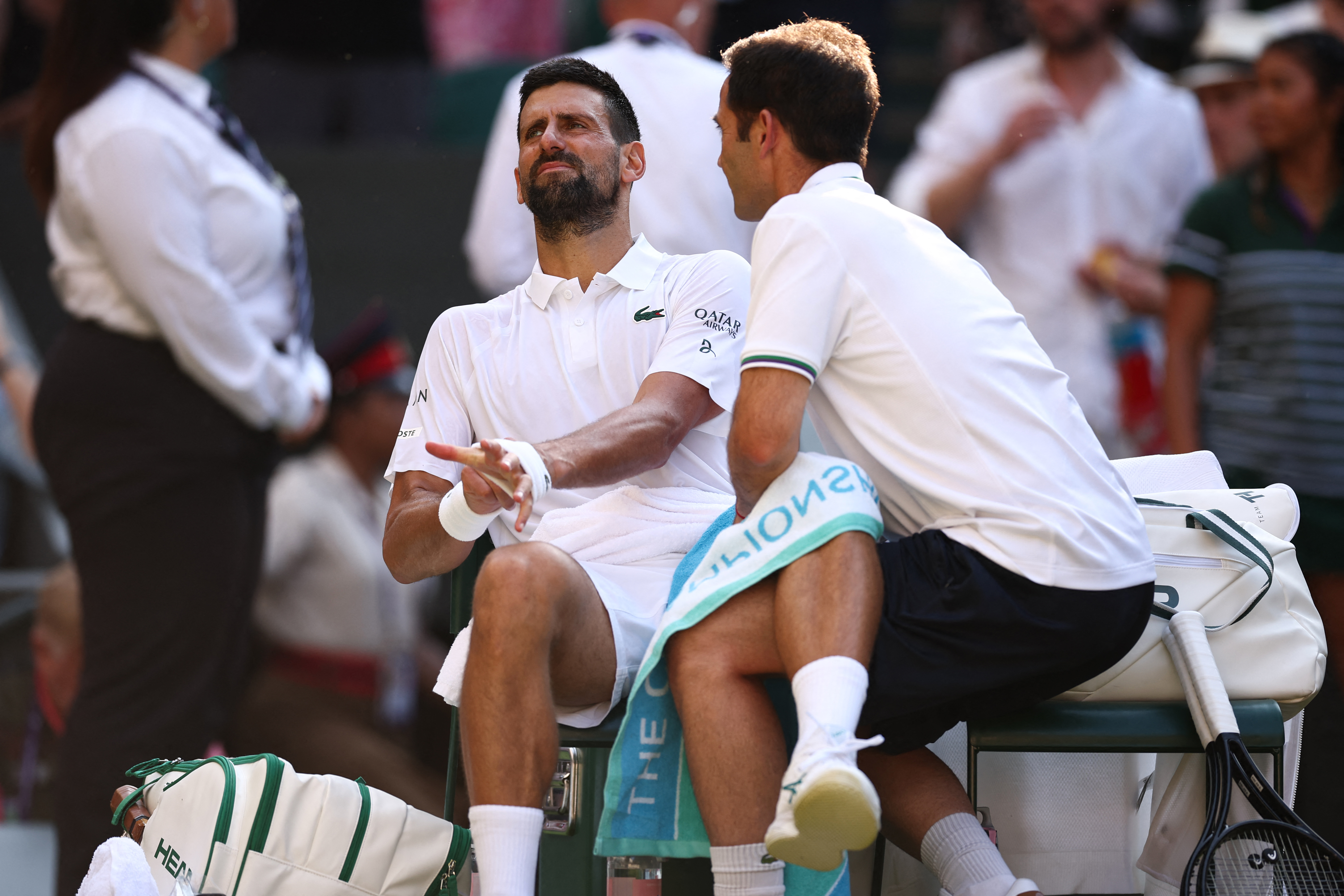 Serbia's Novak Djokovic receives medical treatment during a break as he plays against Italy's Jannik Sinner during their men's singles semi-final tennis match on the twelfth day of the 2025 Wimbledon Championships at The All England Lawn Tennis and Croquet Club in Wimbledon, southwest London, on July 11, 2025. (Photo by HENRY NICHOLLS / AFP) / RESTRICTED TO EDITORIAL USE