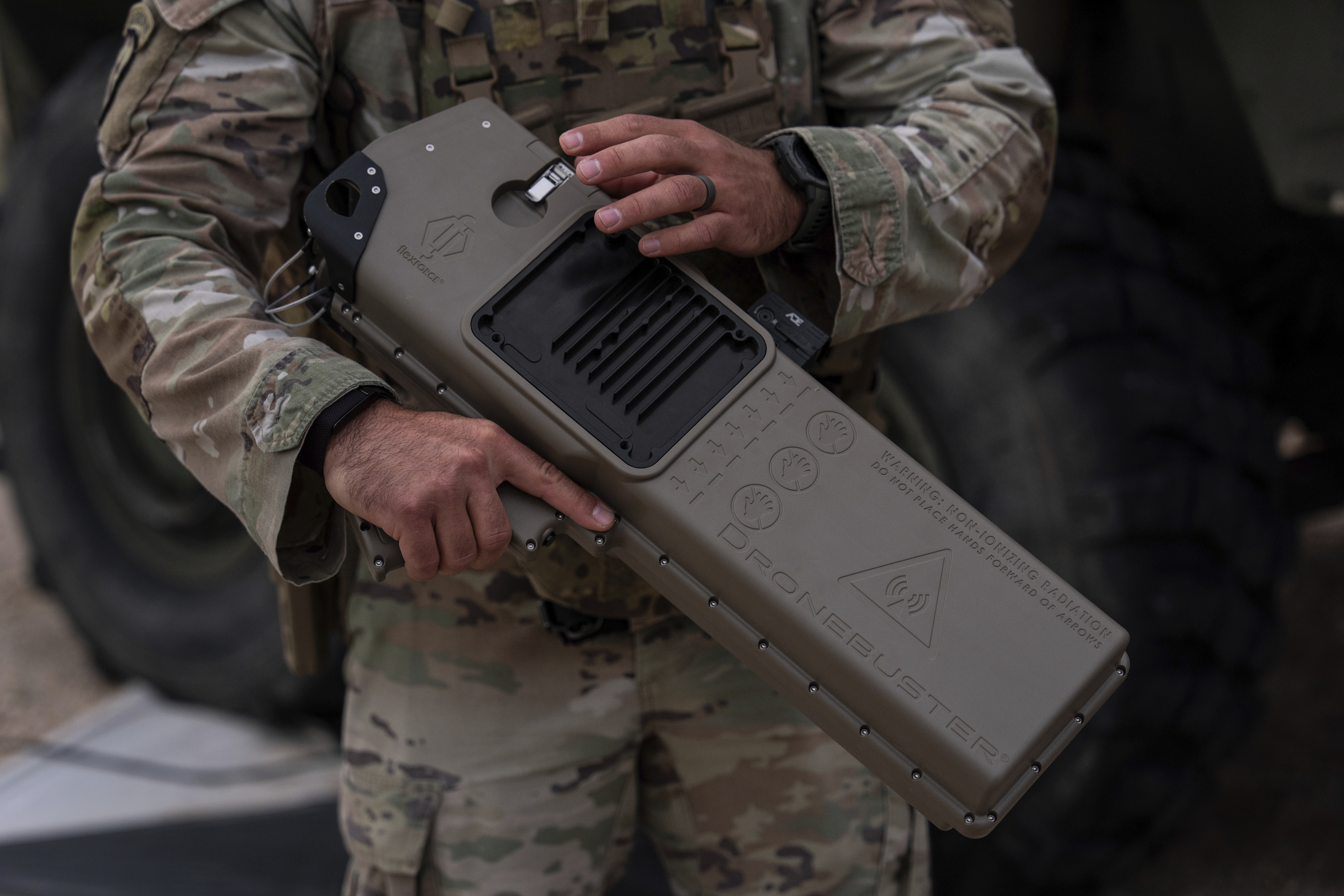 U.S. Army Staff Sgt. Ernesto Nevarez demonstrates how to use the DroneBuster, a handheld device used to disable drones, on Wednesday, July 23, 2025, in Sunland Park, N.M. (AP Photo/Jae C. Hong)
