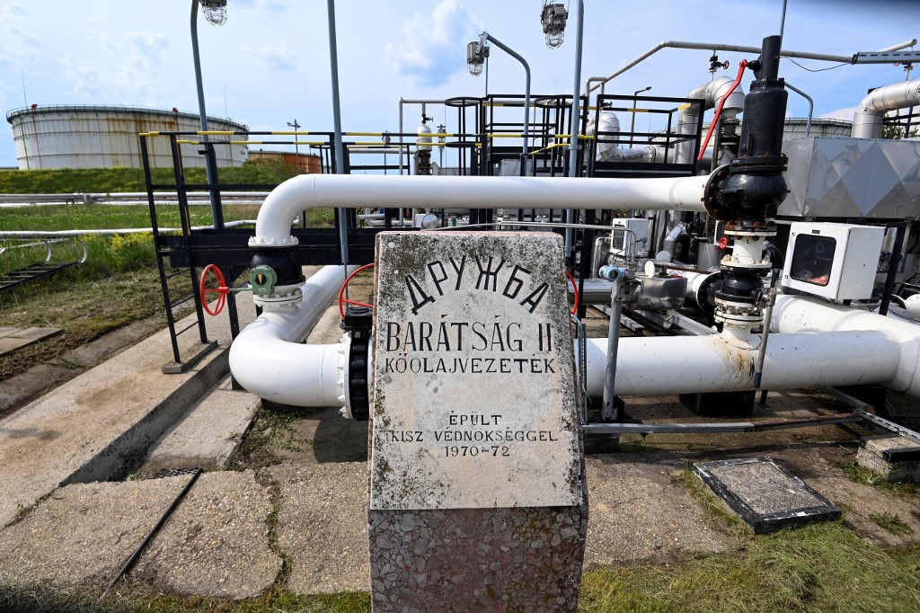A photo taken on May 5, 2022 shows the receiver station of the Druzhba pipeline of petroleum between Hungary and Russia with a memorial plate of its construction at the Duna (Danube) [File: Attila Kisbenedek/ AFP}