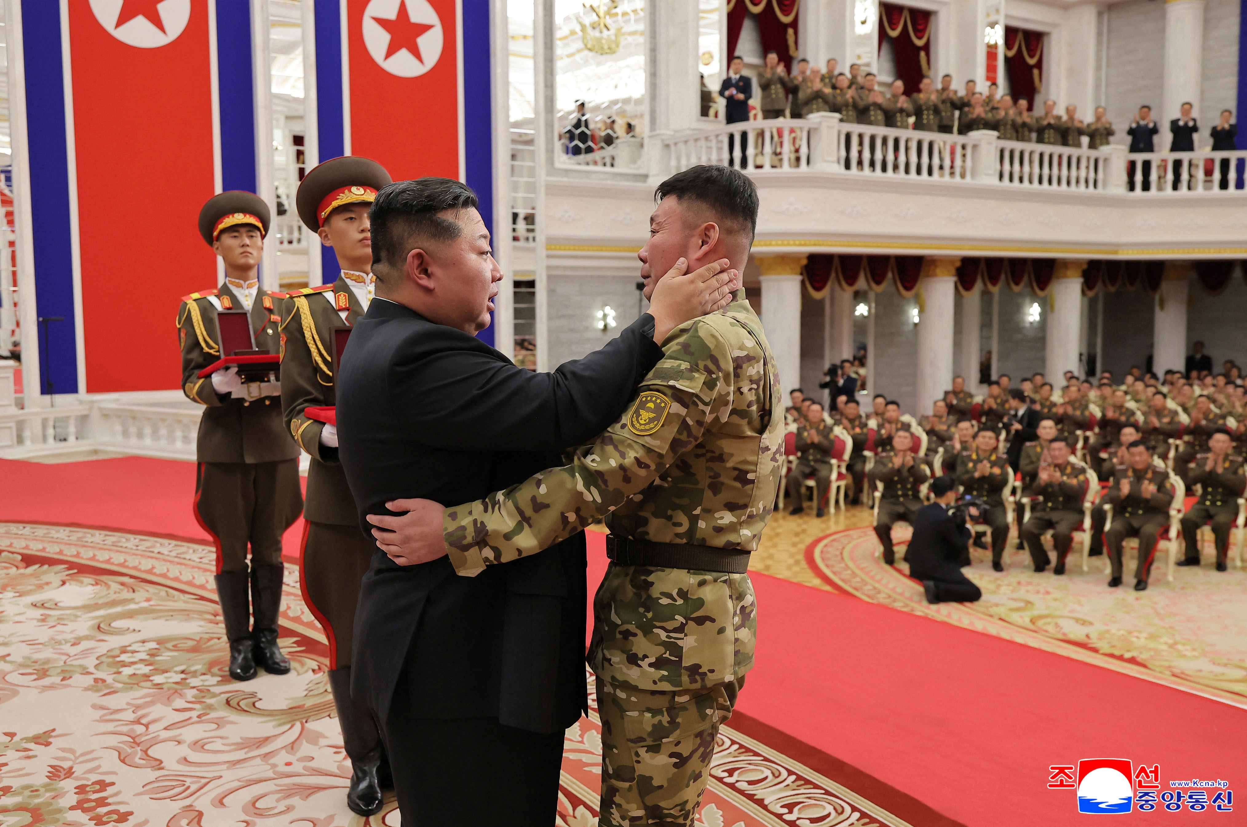This undated picture released from North Korea's official Korean Central News Agency (KCNA) on August 22, 2025 shows North Korean leader Kim Jong Un (L) embracing a serviceman as he attends a ceremony to award state commendations to the commander and combatants of the Korean People's Army's Overseas Operational Forces, who took part in military operations in Kursk Oblast to help Russia in its war against Ukraine, at the headquarters building of the Central Committee of the The Workers' Party of Korea (WPK) in Pyongyang. (Photo by KCNA VIA KNS / AFP) / South Korea OUT / SOUTH KOREA OUT / SOUTH KOREA OUT / ---EDITORS NOTE--- RESTRICTED TO EDITORIAL USE - MANDATORY CREDIT "AFP PHOTO/KCNA VIA KNS" - NO MARKETING NO ADVERTISING CAMPAIGNS - DISTRIBUTED AS A SERVICE TO CLIENTS / THIS PICTURE WAS MADE AVAILABLE BY A THIRD PARTY. AFP CAN NOT INDEPENDENTLY VERIFY THE AUTHENTICITY, LOCATION, DATE AND CONTENT OF THIS IMAGE --- /