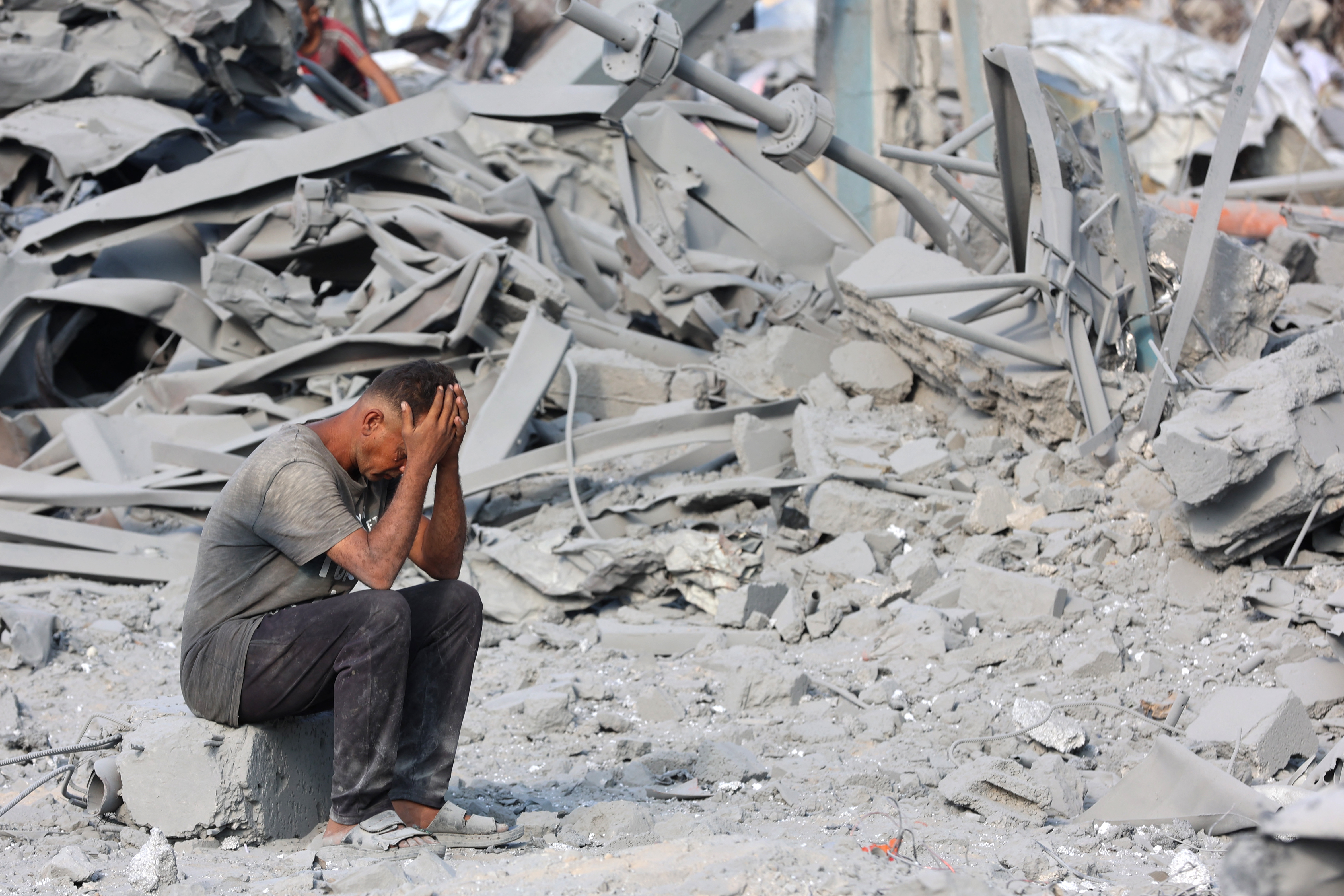 A Palestinian man reacts to the destruction after an overnight strike on the Sheikh Radwan Health Centre run by the United Nations Relief and Works Agency for Palestine Refugees (UNRWA) in the north of Gaza City on August 6, 2025.