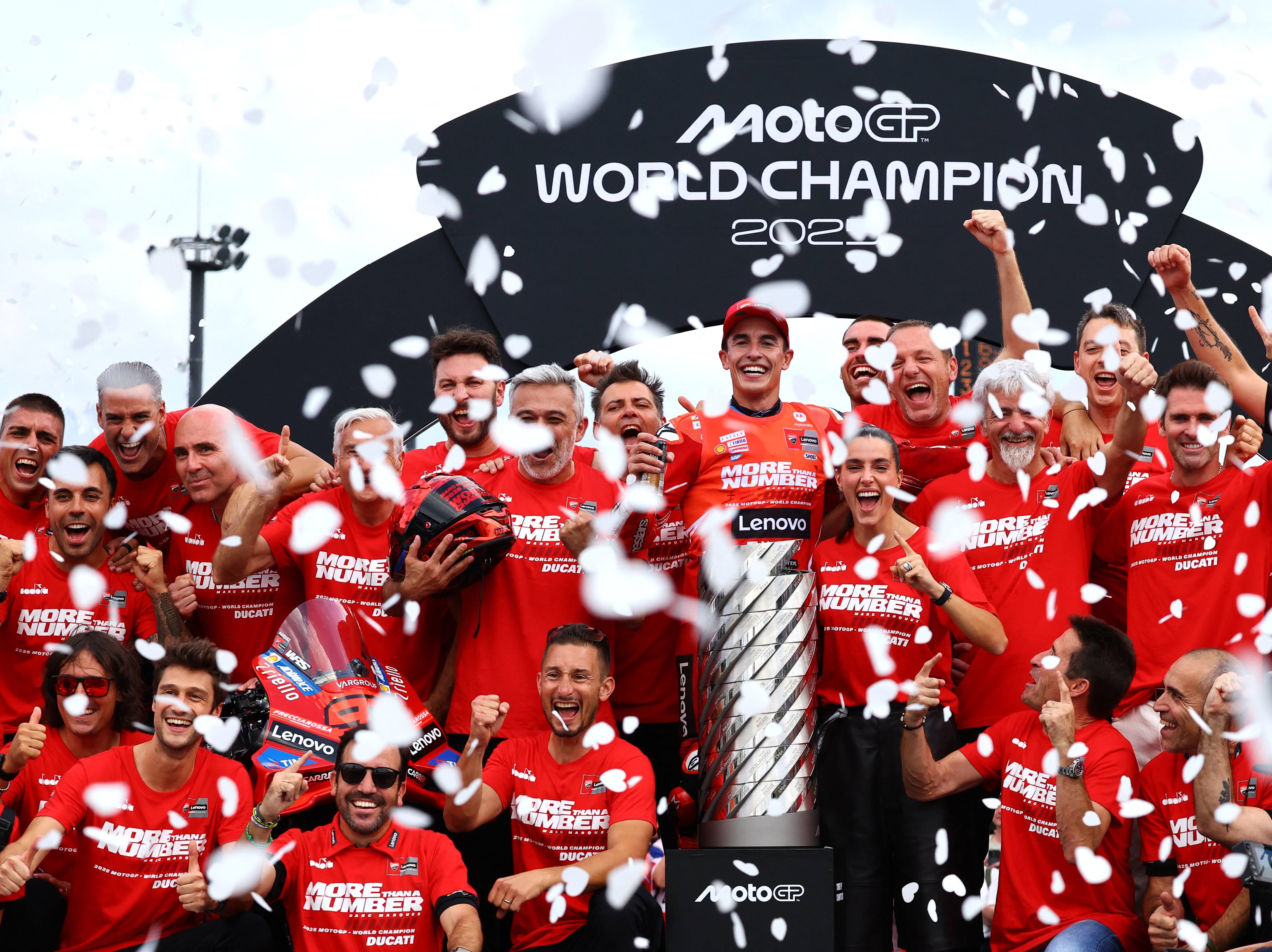 Marquez, centre, celebrates on the podium with his Ducati Lenovo teammates after the Japanese MotoGP