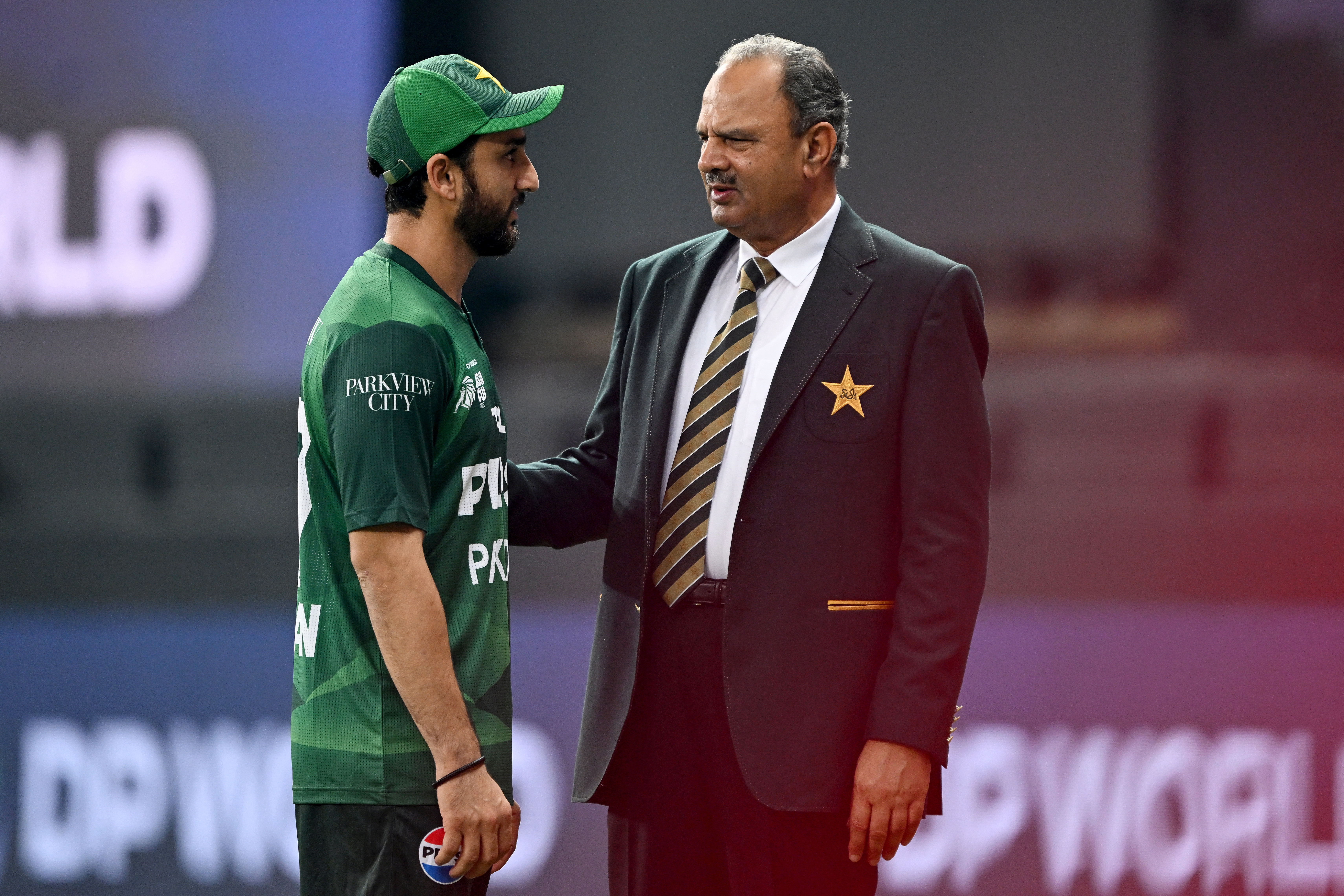 Pakistan's captain Salman Agha (L) and team manager Naveed Akram Cheema speak before the start of the Asia Cup 2025 Twenty20 international cricket match between United Arab Emirates and Pakistan at the Dubai International Stadium in Dubai on September 17, 2025. (Photo by Sajjad HUSSAIN / AFP)